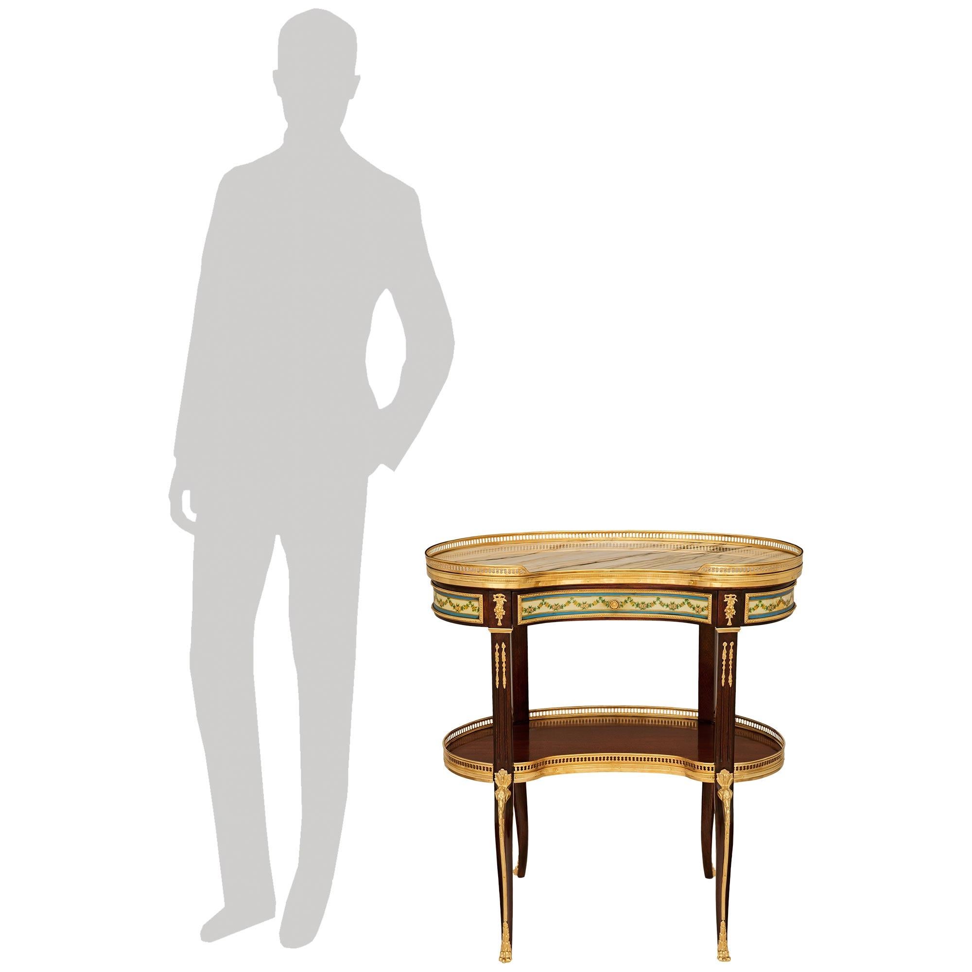 An exquisite and high quality French 19th century Transitional st. Mahogany, Ormolu, Sévres Porcelain and Calacatta marble side table. This most elegant kidney shaped table is raised on four cabriole legs accented with Ormolu sabots and foliate top
