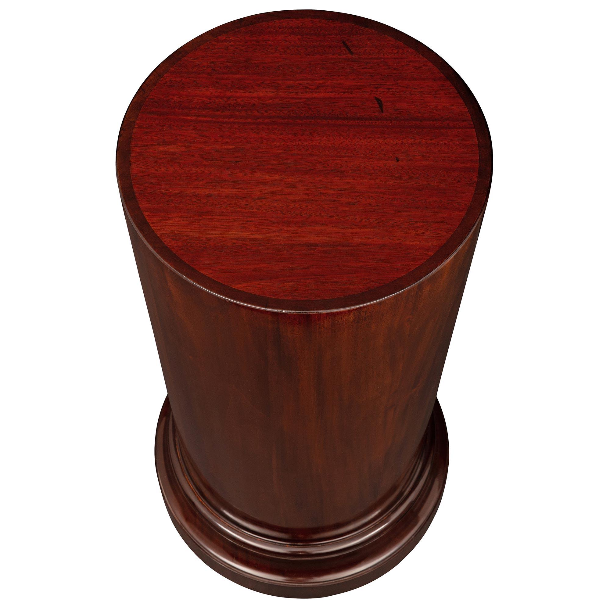 An extremely elegant French 19th century mahogany pedestal column. The circular pedestal is raised by a fine mottled base below the circular central support highlighting the beautiful mahogany grain.

Top diameter: 13.5