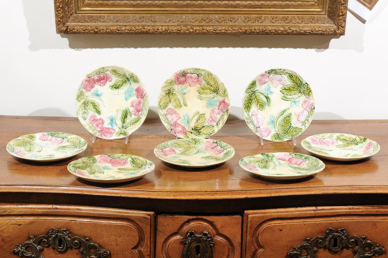 A set of French Majolica strawberry plates from the 19th century, with pink, green and blue accents, priced and sold individually. Each of these eight French plates features a delicately shaped Silhouette, accented with a charming raised décor of