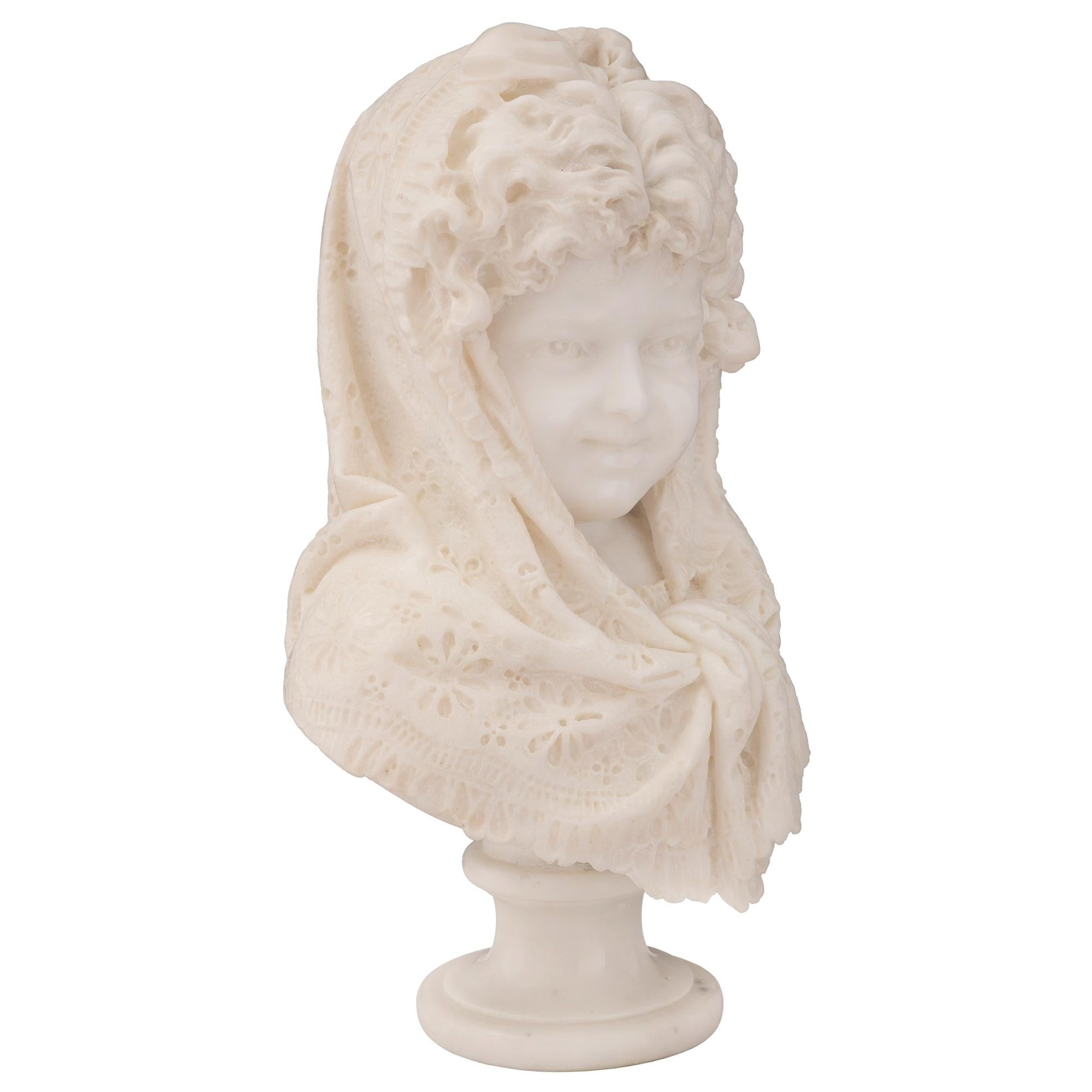 A stunning and finely detailed French 19th century white Carrara marble bust of a young girl, signed Zanatone Milano. The bust is raised by an elegant circular socle pedestal shaped base with a fine mottled border. Above is the beautiful and most