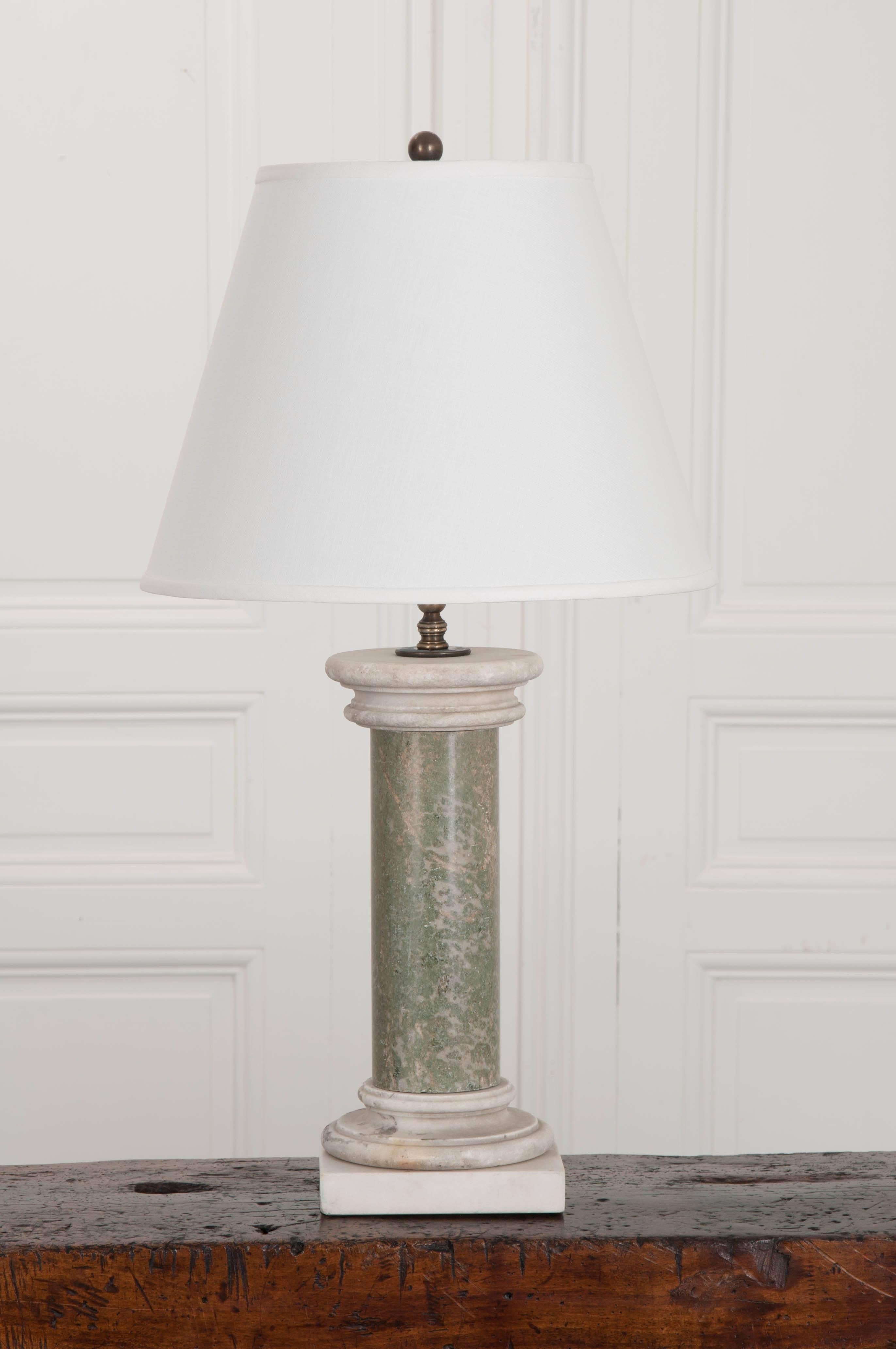 This custom light fixture was made using a column-form baluster from a grand 19th century French marble staircase. The marble is a wonderful pale Kiwi green with natural and grey-colored veins. The capital and base are also made of marble, however