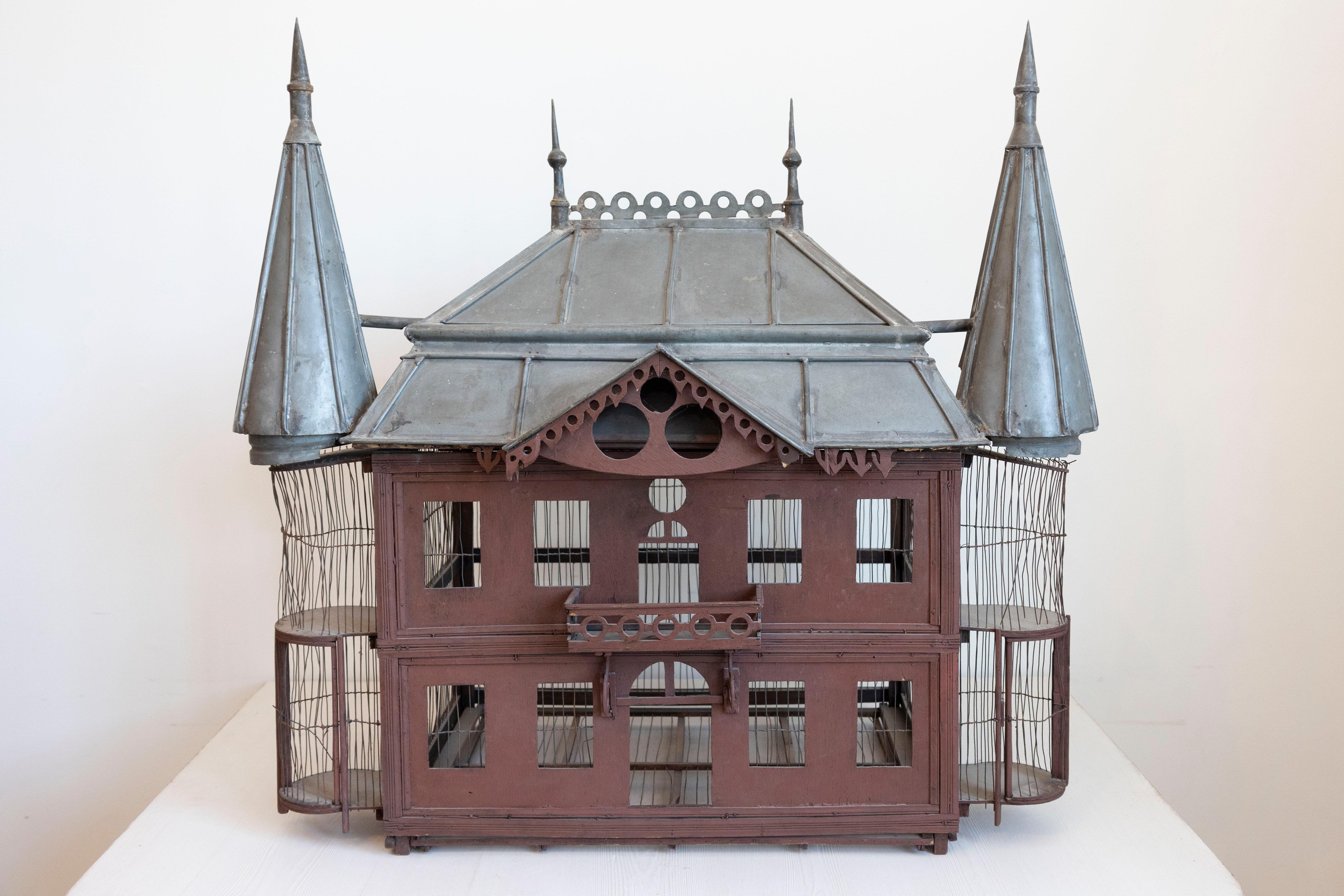 A large 19th century pewter and wood decorative birdcage shaped as a French medieval château. This exquisite French château birdcage is a definite must in terms of decorative accents. While the facade, with its perfect regularity, could evoke a 17th
