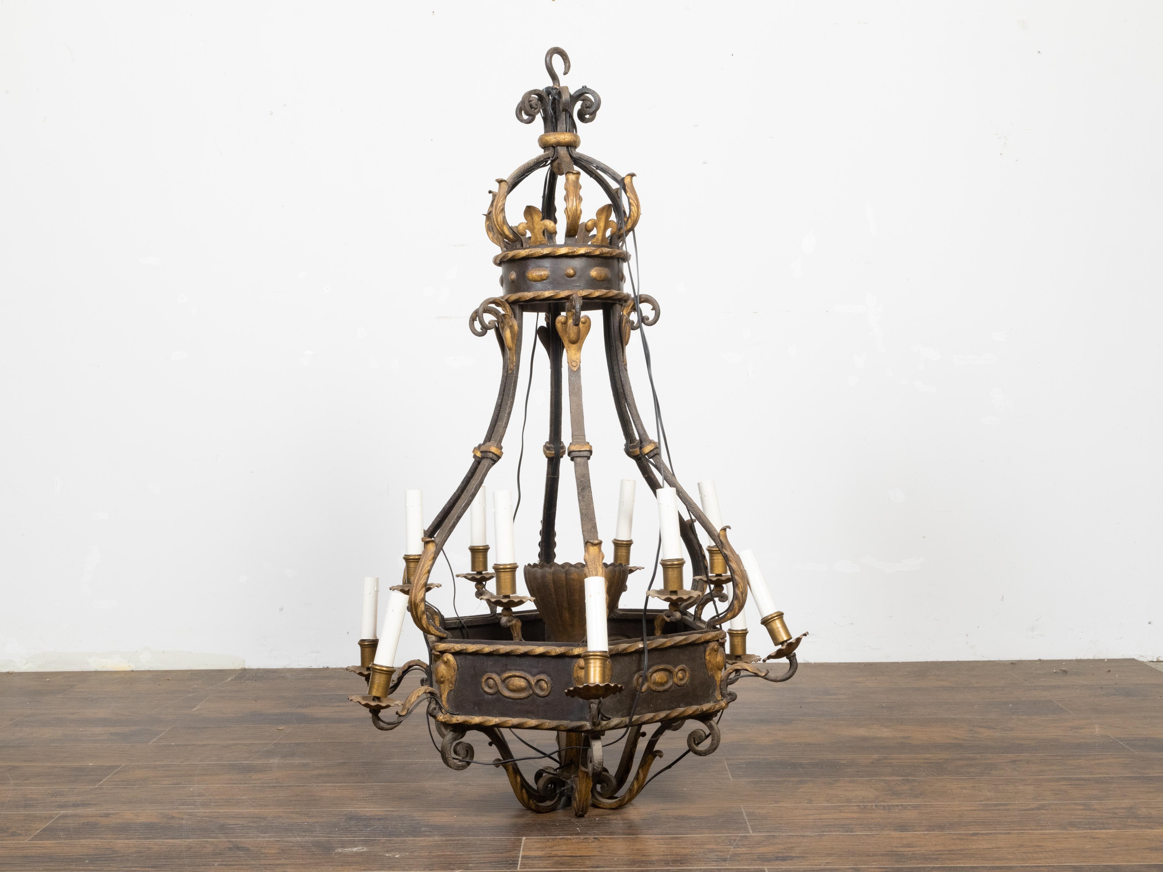A French metal 12-light crown chandelier from the 19th century with gilded accents. Illuminate your home with the grandeur of 19th-century French elegance embodied in this exquisite metal 12-light crown chandelier. Adorned with gilded accents, this