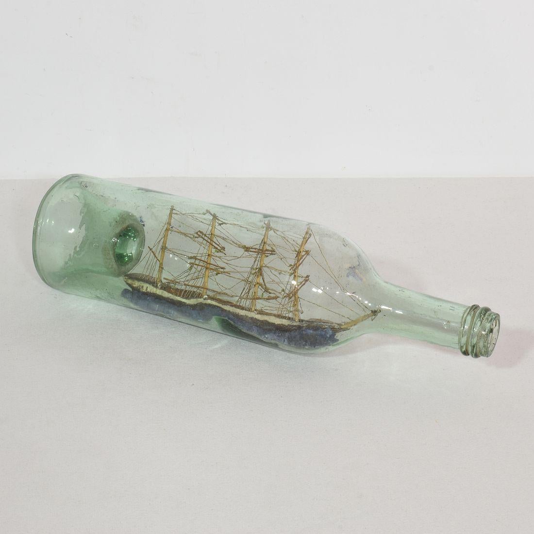 A very rare model ship within a bottle.
These most collectible pieces can be described as folk art and were often made at sea by sailors with spare time to fill when not working on deck.
France circa 1850. Weathered but good condition.
