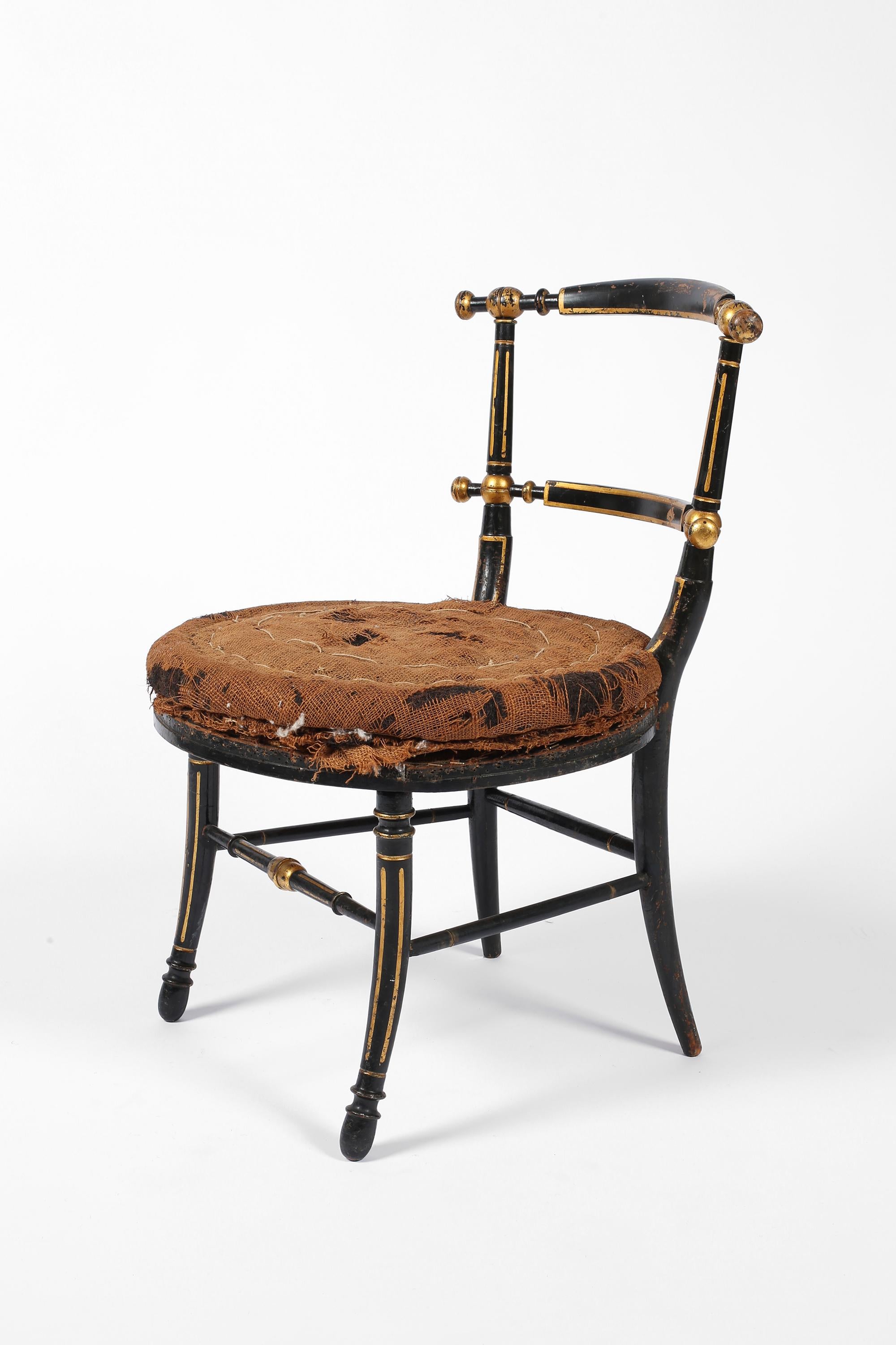 A charming Napoleon III occasional chair in turned, ebonised and parcel gilt beech timber. In original un-upholstered condition, with visible, distressed horse hair and hessian seat pad. French, c. 1850.