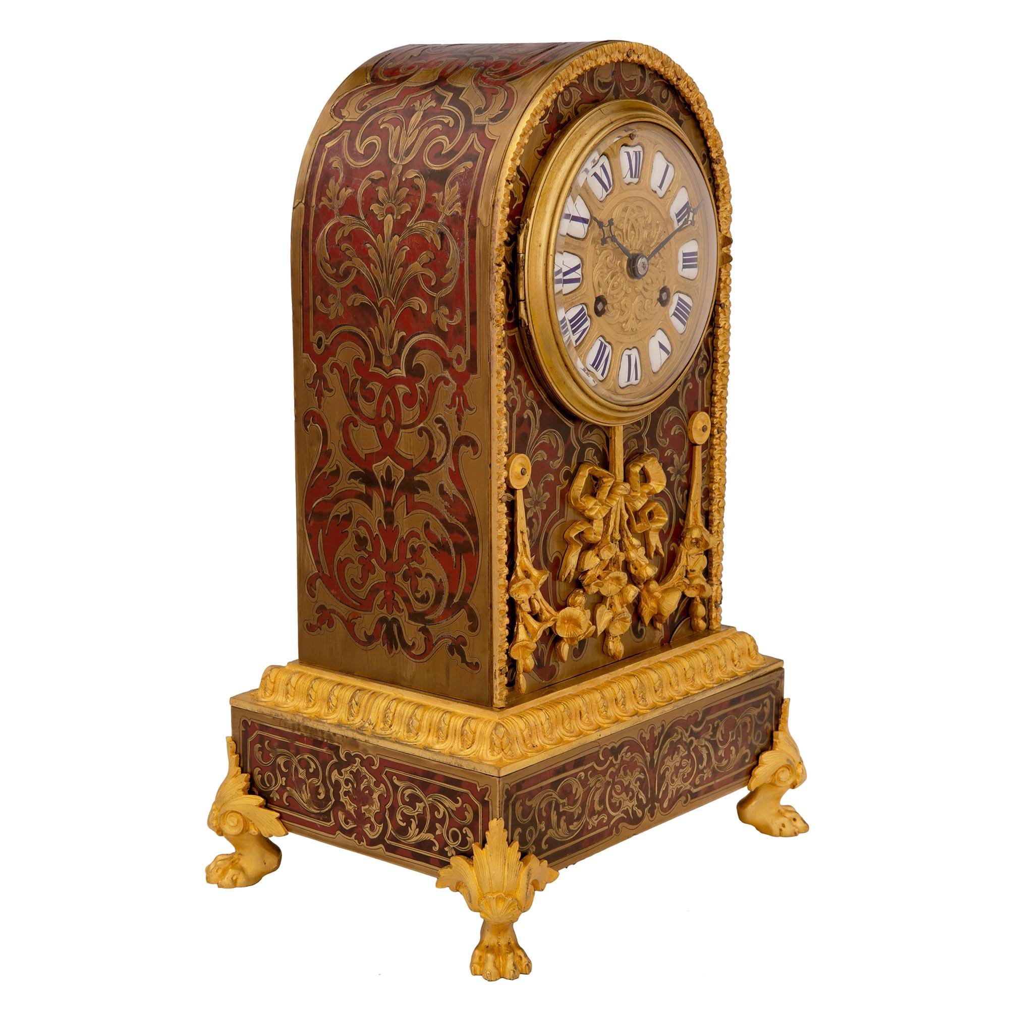 A striking high quality French 19th century Napoleon III period ormolu, tortoiseshell, and brass inlaid Boulle clock. The clock is raised by handsome ormolu paw feet with acanthus leaves below the rectangular base. The base displays stunning