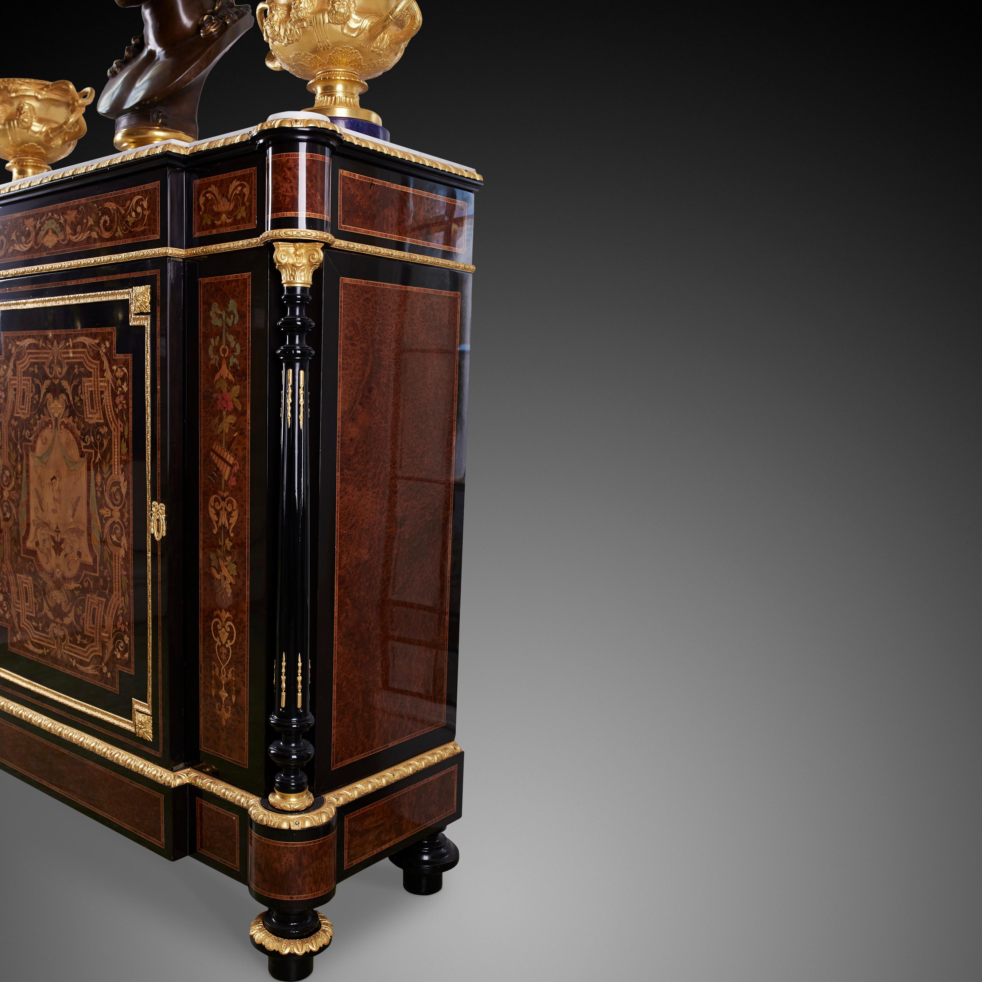 A stunning French 19th century Napoleon III period ebony, ormolu, marble and exotic wood cabinet. The cabinet is raised by elegant topie shaped feet with fine foliate ormolu bands. The base displays beautiful fitted rectangular burl walnut designs