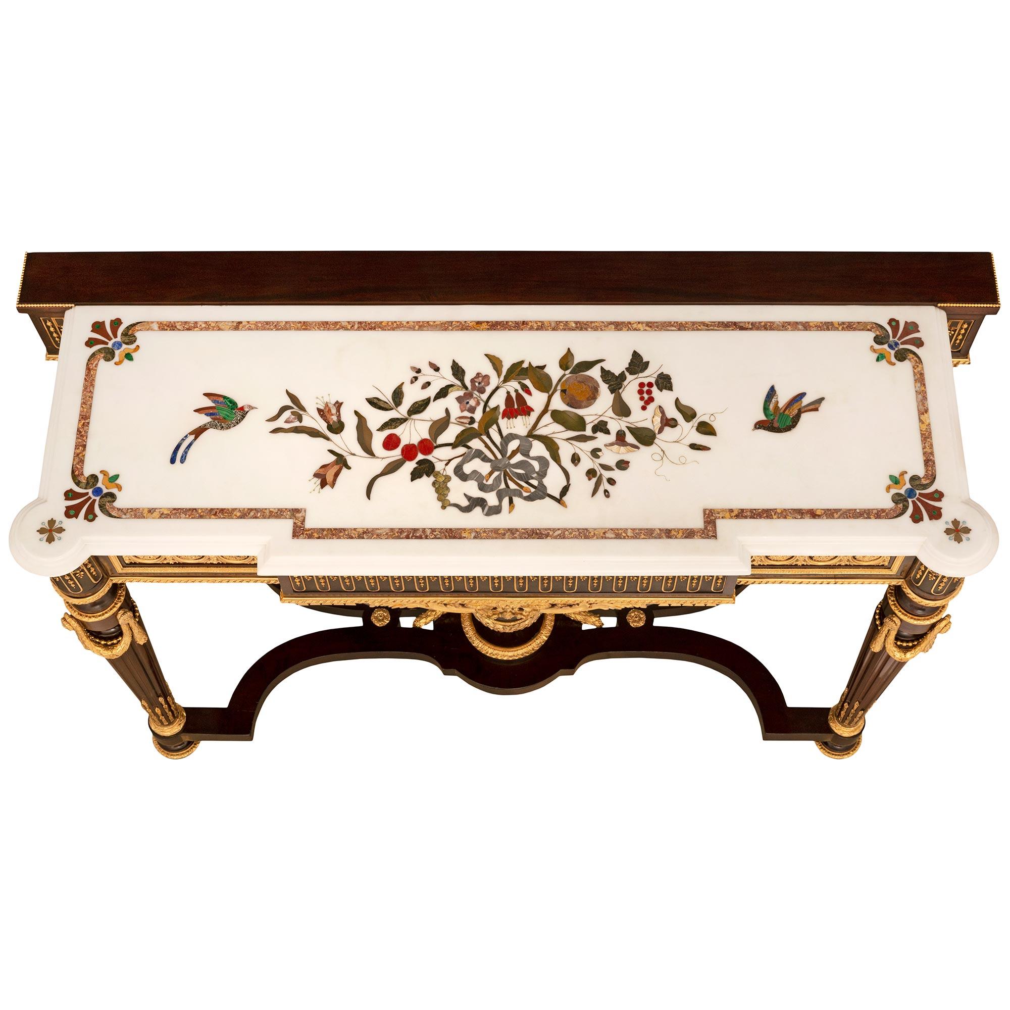 An exceptional and high quality French 19th century Louis XVI st. Napoleon III Period Mahogany, Ormolu and marble console. The freestanding console is raised by four topie shaped feet below richly decorated circular fluted tapered legs with the top