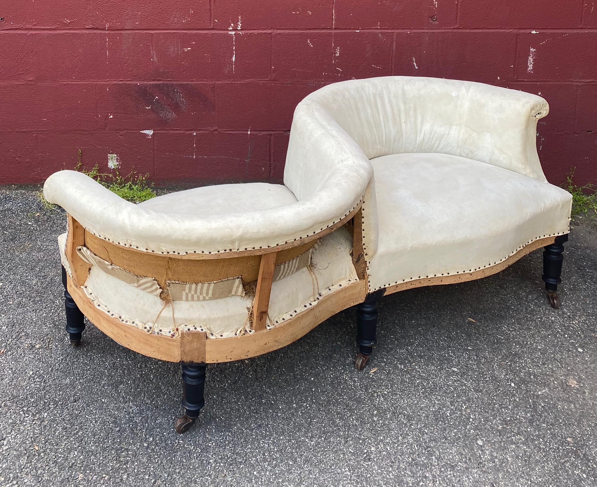A whimsical and unusual Napoleon III “double”  armchair referred to in French as a Tête-à-Tête, meant to imply an intimate head to head conversation. The opposite facing seats are joined together to from a serpentine form. The piece is ready to