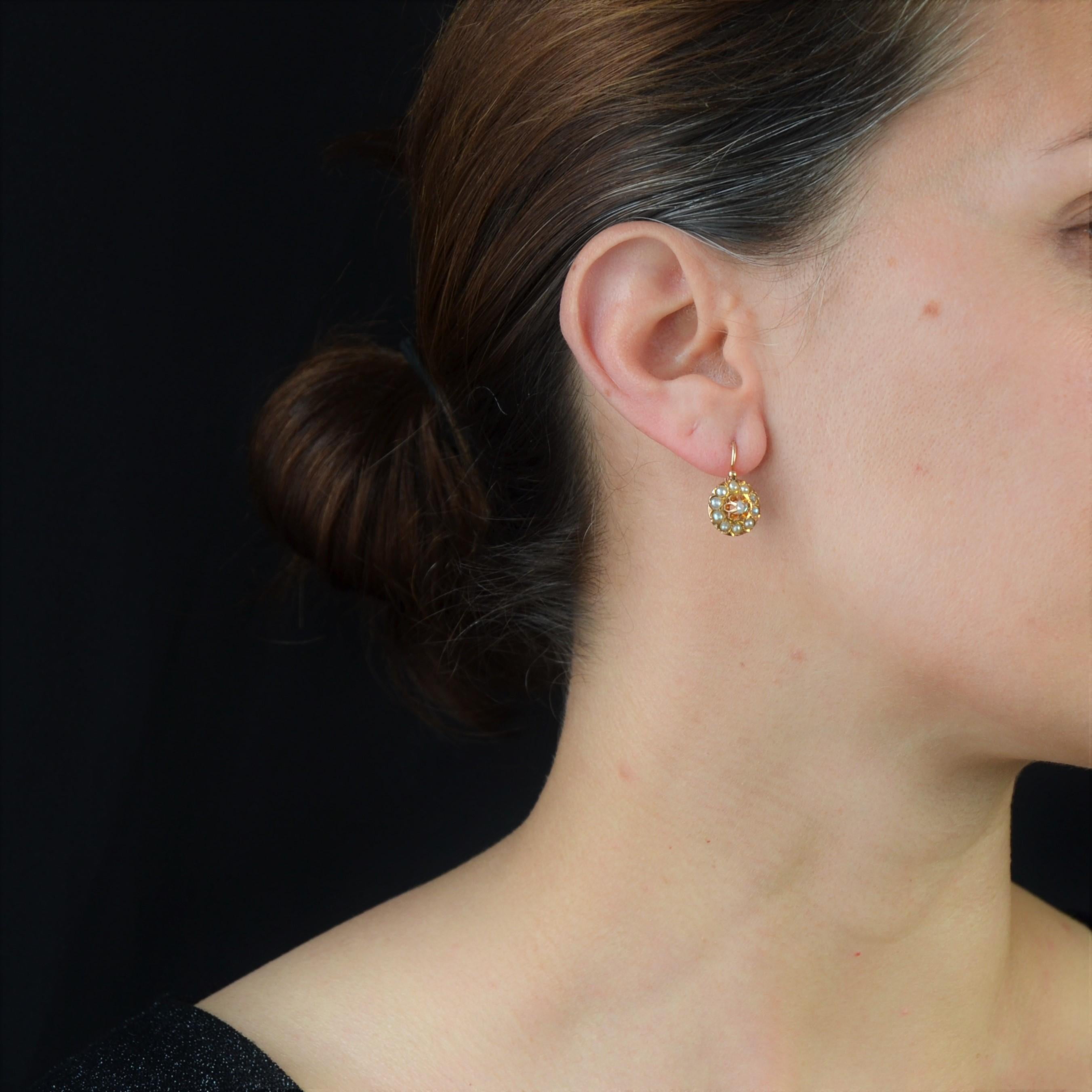 For pierced ears.
Earring in 18 karat rose gold, horse head hallmark.
Called lever- back earrings, because they could be worn at night, these antique earrings are flower-shaped, the heart being decorated with a rose-cut diamond, and the petals