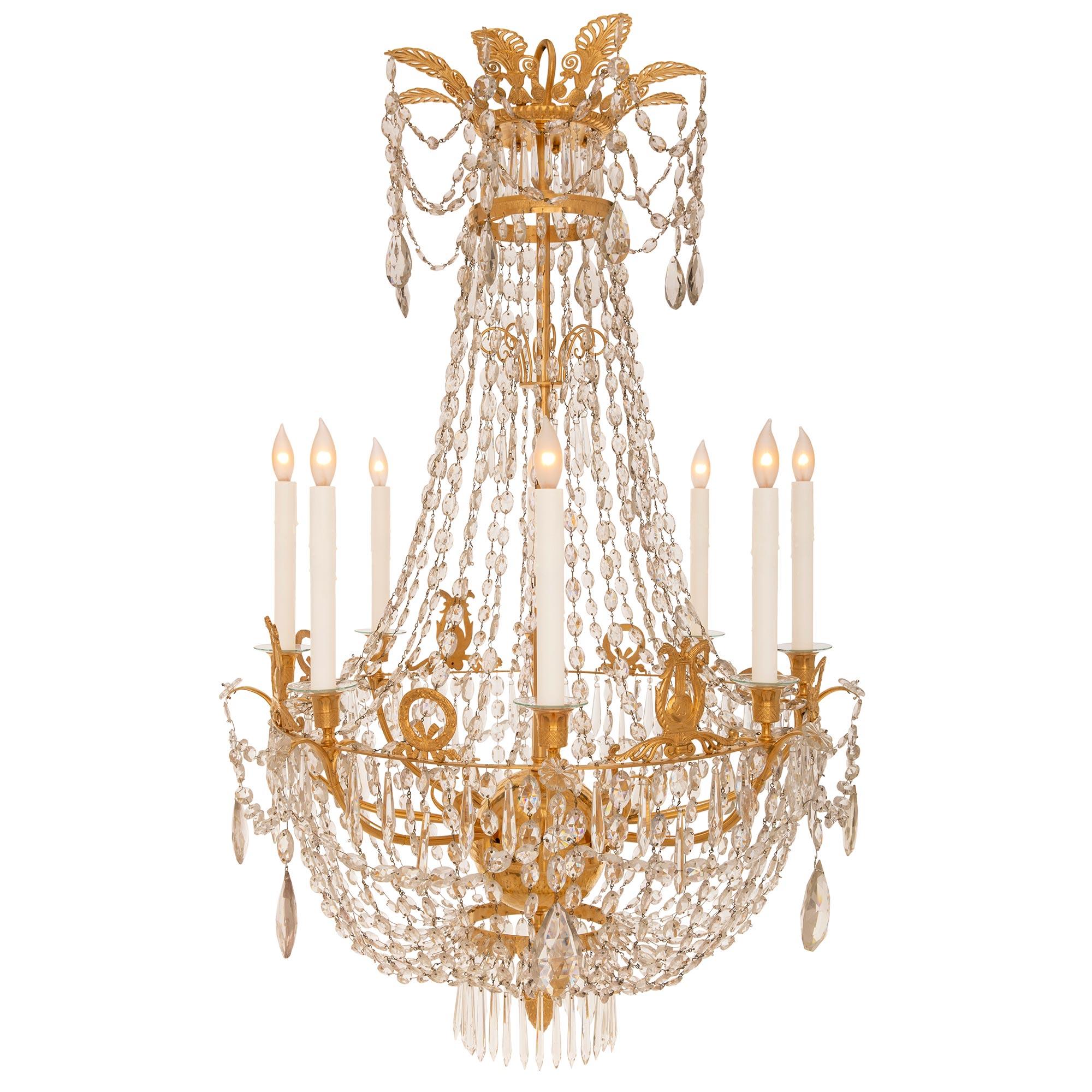 An exceptional French 19th century Neo-Classical st. Baccarat crystal and ormolu chandelier. The eight arm chandelier is centered by a fine bottom acorn finial amidst a lovely array of prism shaped cut crystal pendants. Elegant swaging cut crystal
