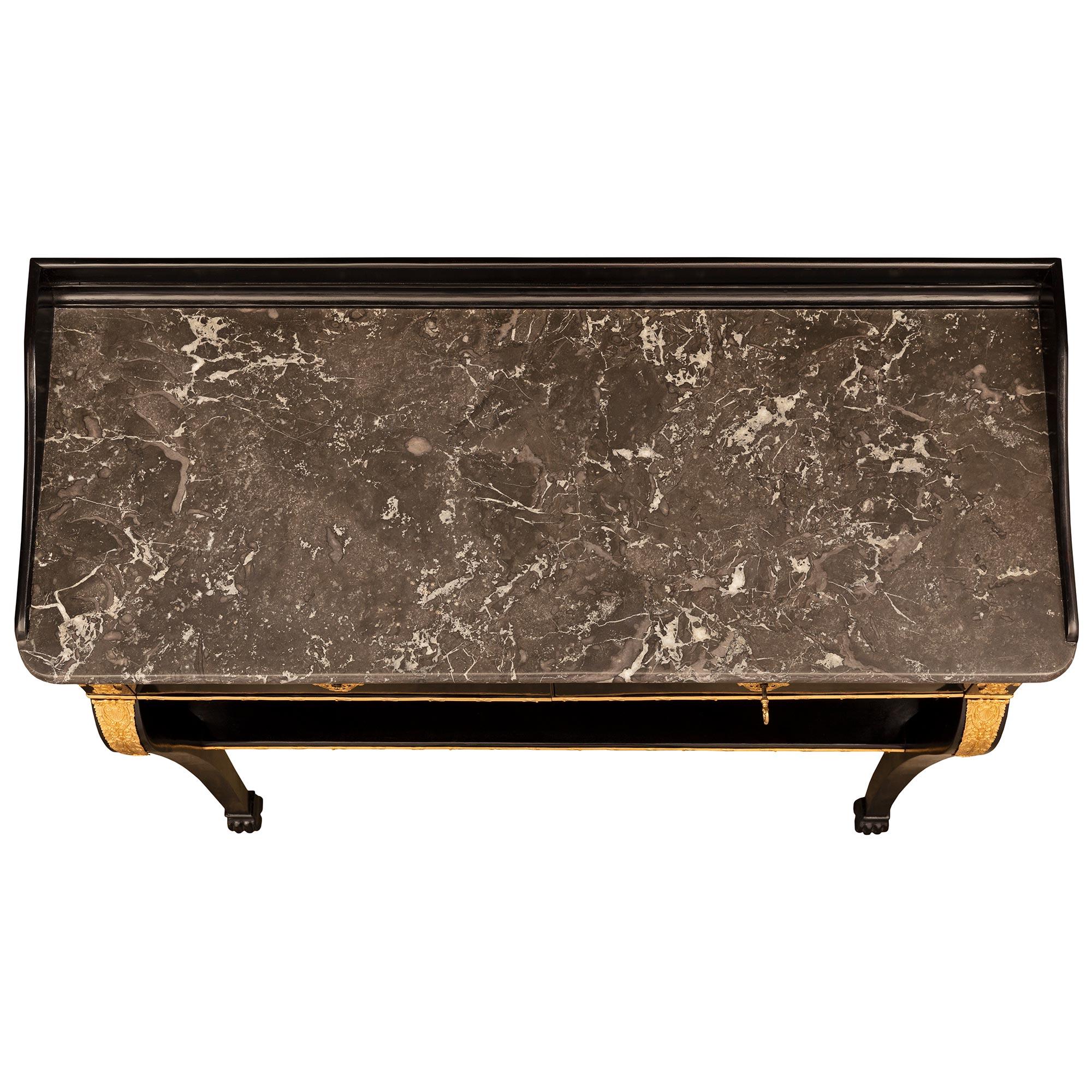 A striking and very unique French 19th century Neo-Classical st. ebonized Fruitwood and Sainte-Anne des Pyrénées marble console. The freestanding console is raised by elegantly scrolled legs at the front with handsome paw feet and straight legs with