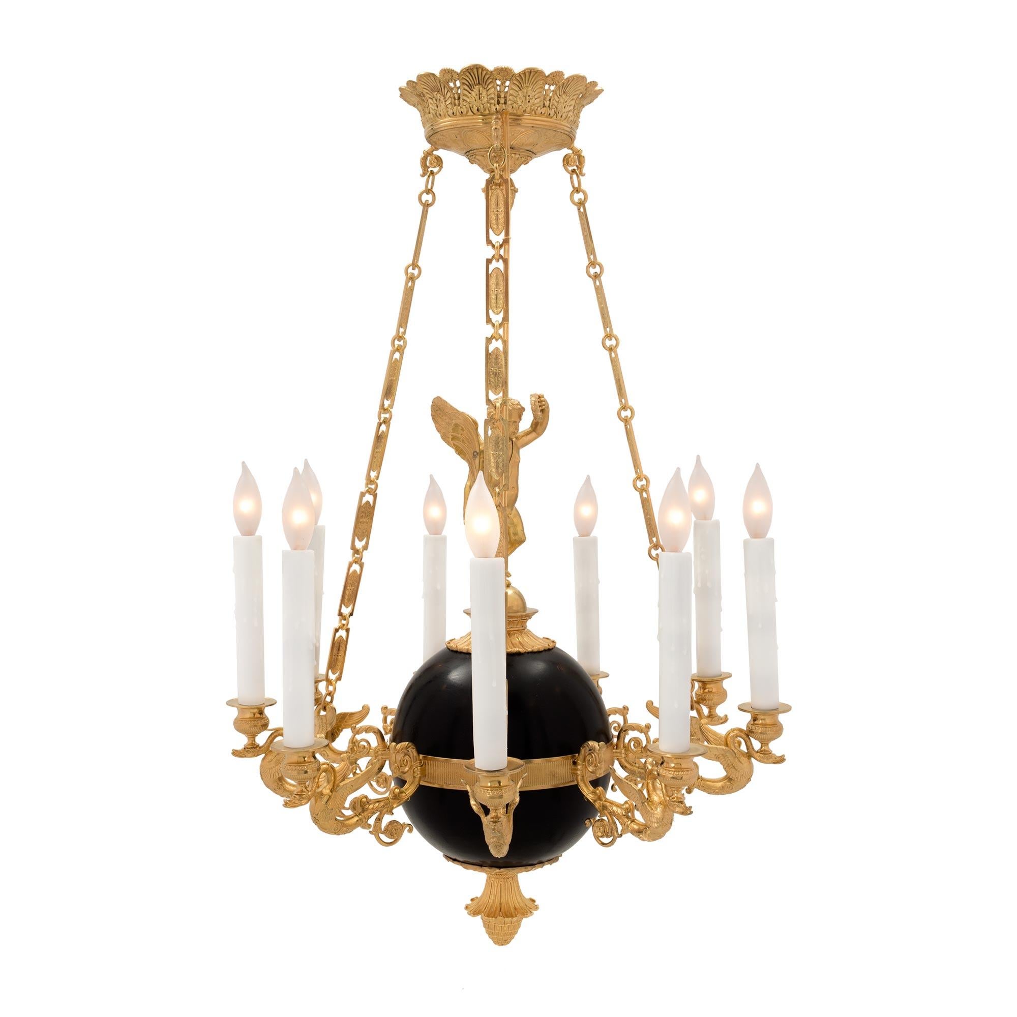 A superb French 19th century Neo-Classical st. ormolu and patinated bronze nine arm chandelier. The chandelier is centered by a richly chased bottom acorn finial below the central patinated bronze ball. Standing on the ball is a charming and
