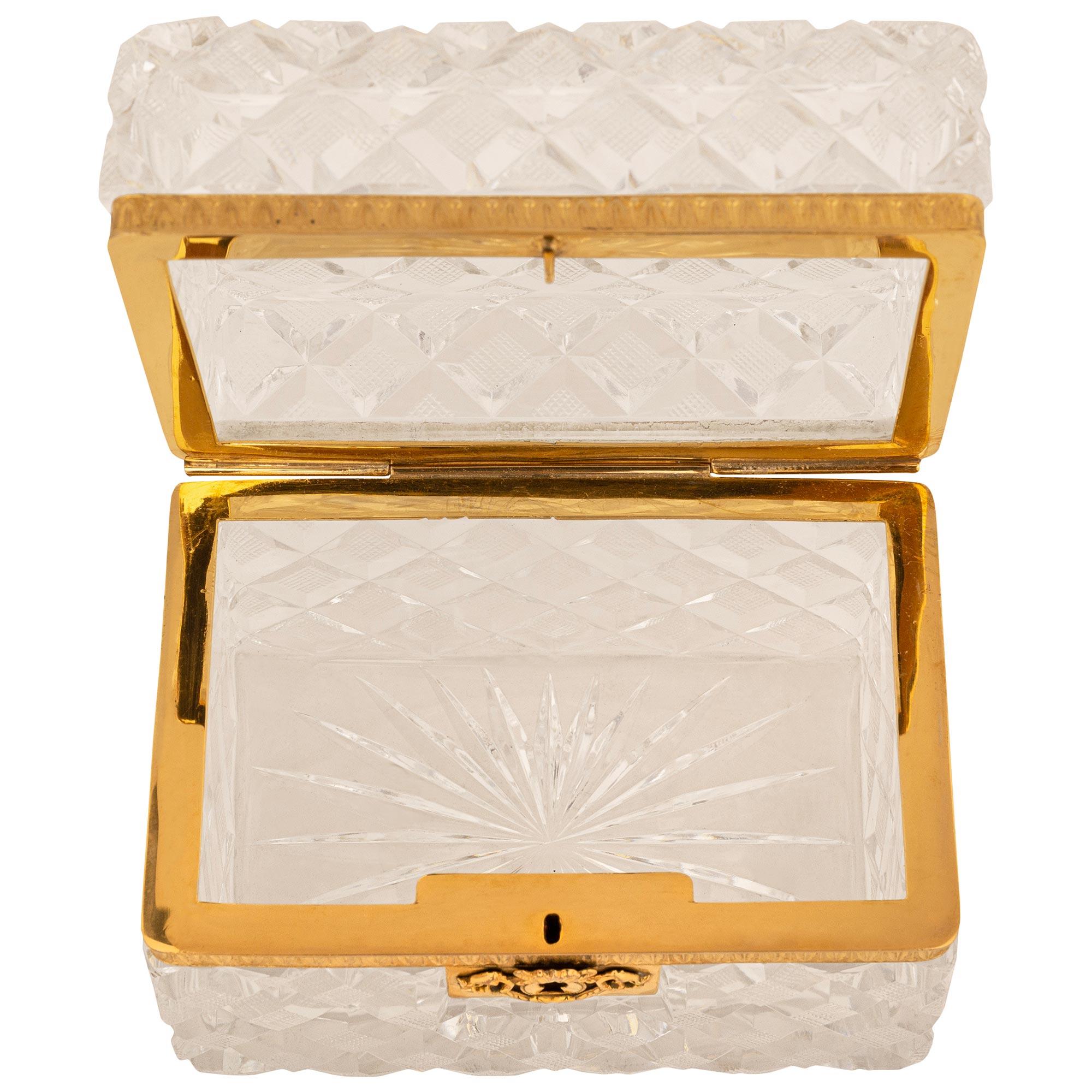 A stunning and finely detailed French 19th century Neo-Classical st. Ormolu and Crystal box. This beautiful Crystal box displays a wonderful thick Crystal body with lattice designed cuts and a scrolling foliate designed Ormolu keyhole escutcheon.