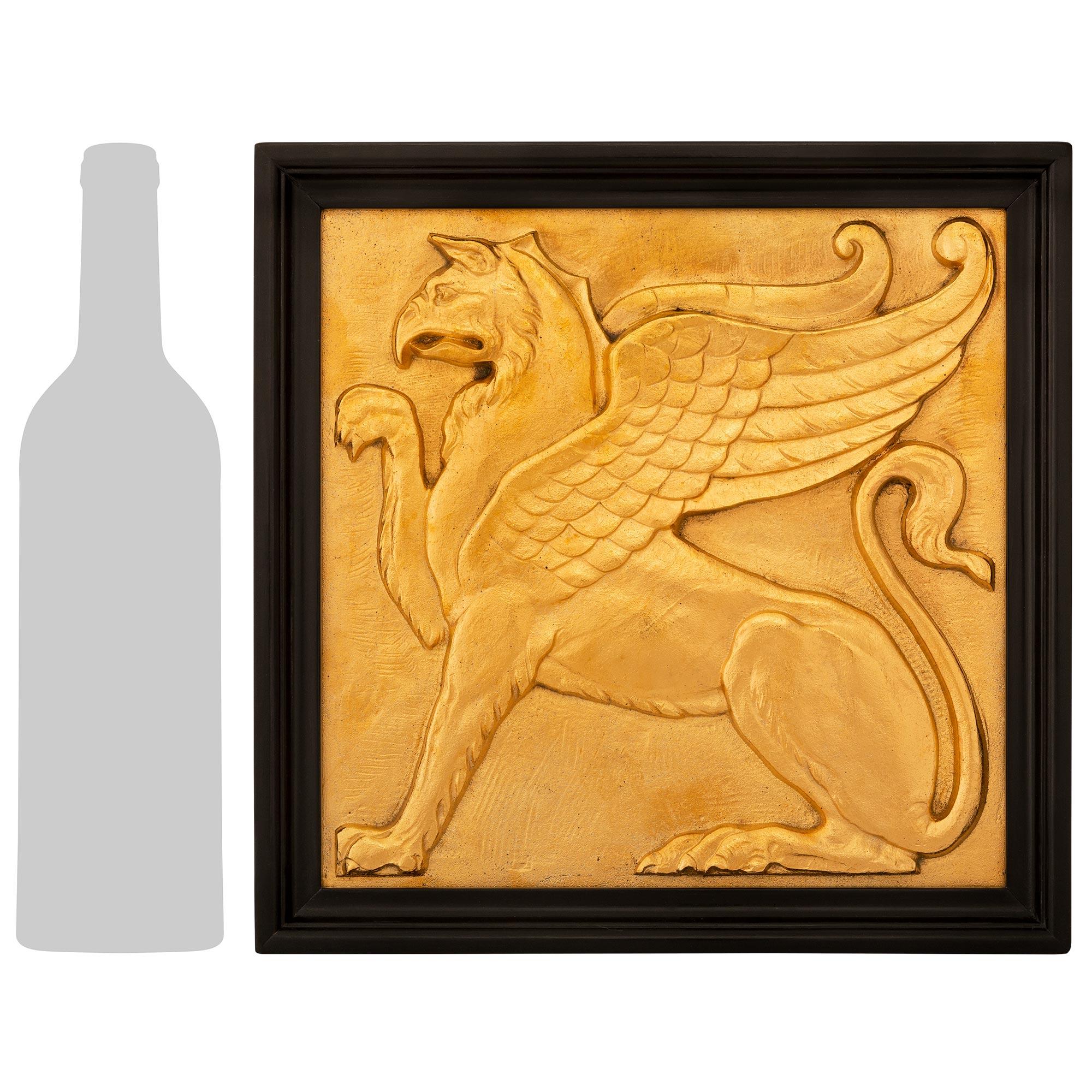 A very unique and powerful true pair of French 19th century Neo-Classical st. Ormolu and Ebony wall plaques. Each most decorative plaque is set within a think Ebony frame displaying a mottled edge. Both Ormolu plaques showcase a handsome