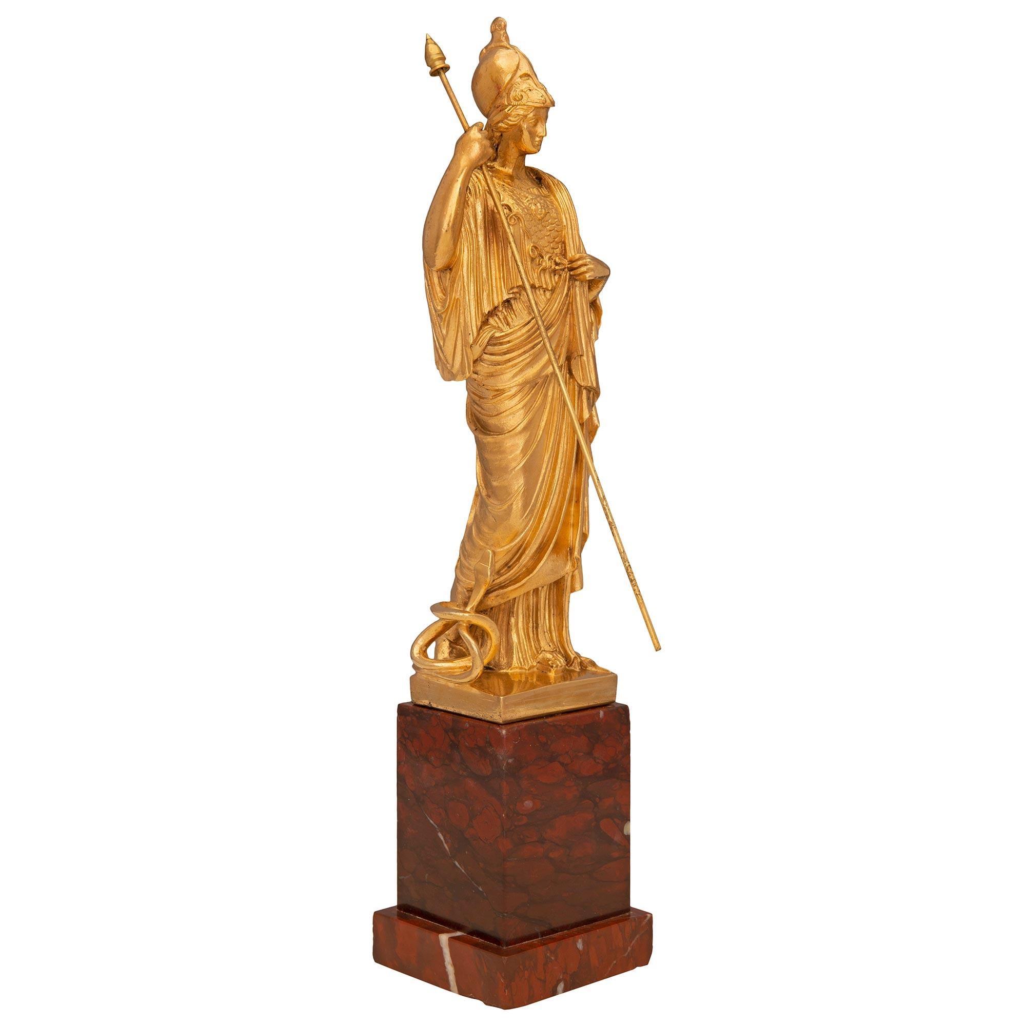 A striking and very high quality French 19th century neo-classical st. ormolu and Rouge Griotte statue of Athena. The statue is raised by an elegant square Rouge Griotte marble base with a fine stepped design. The impressive and finely detailed