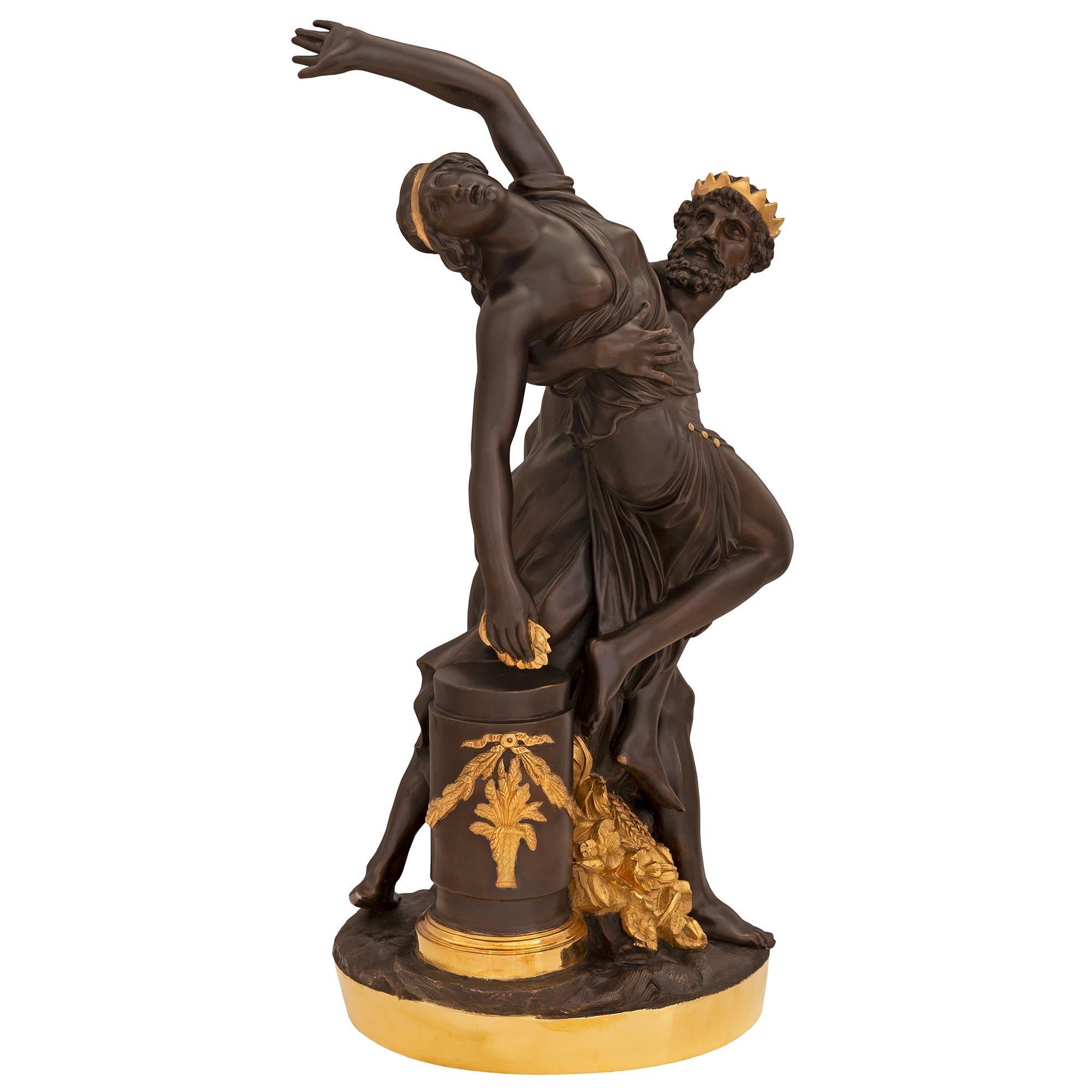 An exceptional and extremely high quality French 19th century Neo-Classical st. Belle Époque period patinated bronze and ormolu statue of Demeter and Poseidon. The impressive statue is raised by a circular ormolu base with a wonderfully executed