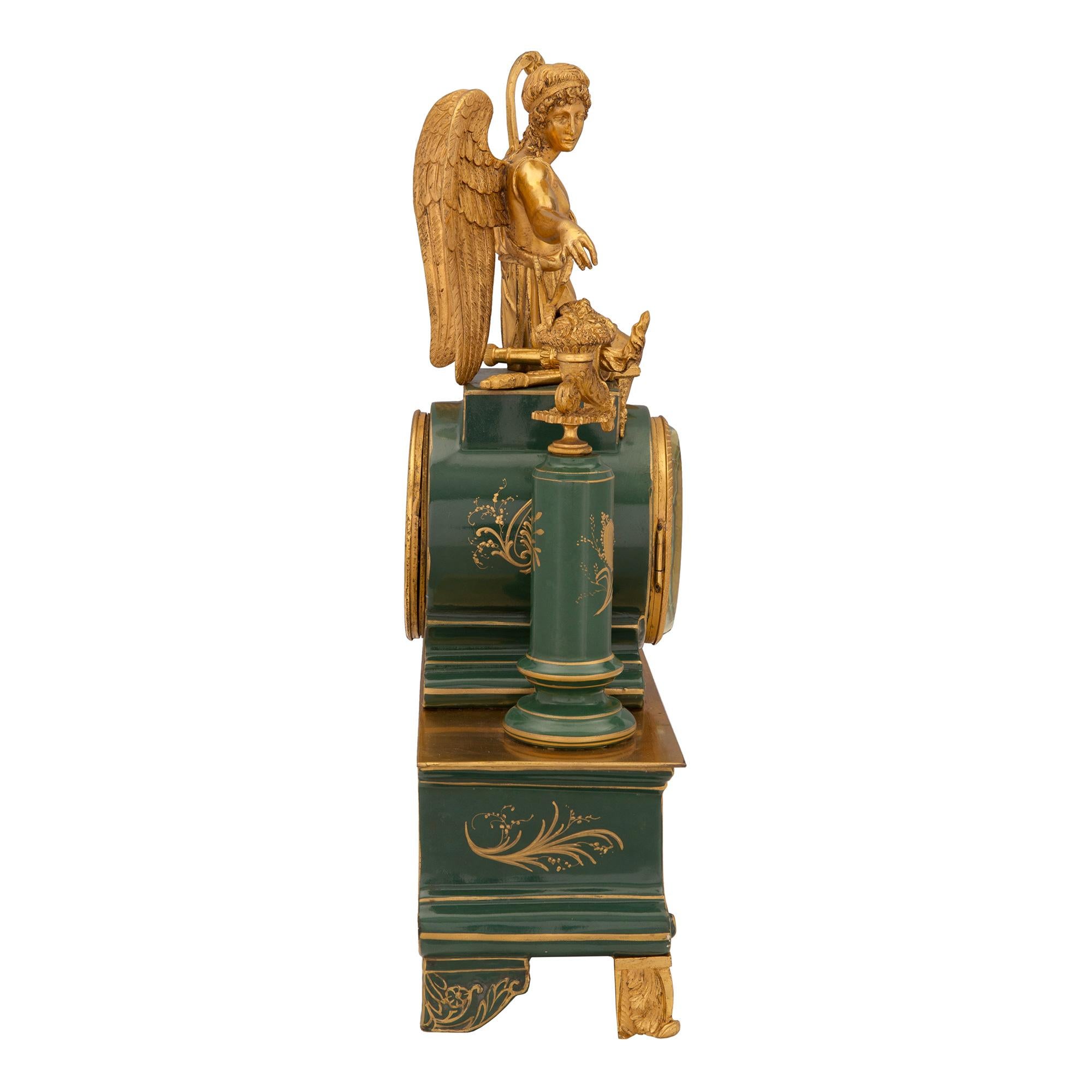 A most attractive French 19th century neo-classical st. porcelain and ormolu clock. The clock is raised by fine scrolled ormolu feet below the beautiful deep forest green porcelain base. The base is centered by a lovely and most charming hand
