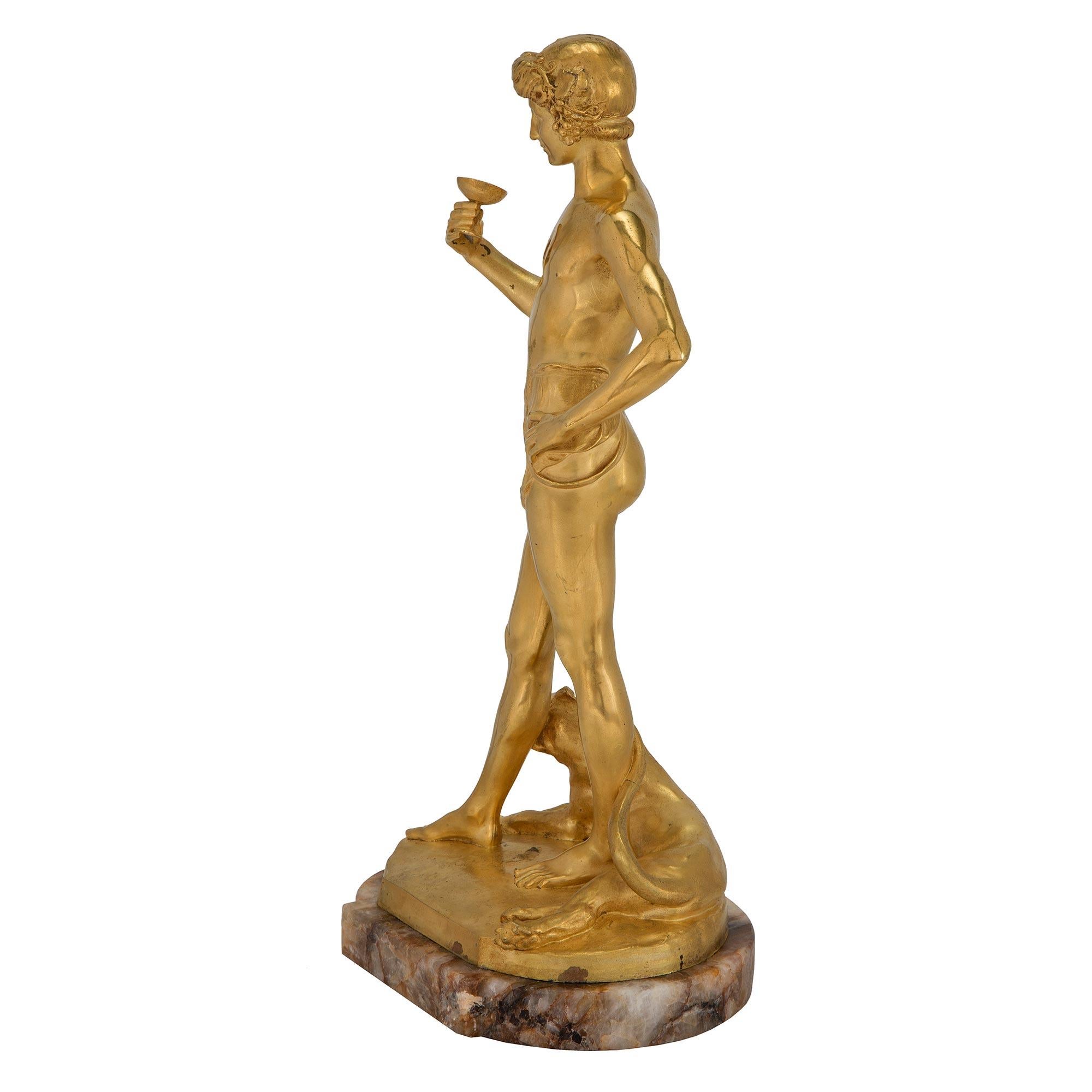 A handsome and high quality French Turn of the Century Neo-Classical st. Ormolu and Quartz statue of Aquarius, signed Antonin Carlès. This handsome statue is raised on an oval Quartz base which follows the contours of the Ormolu statue above. This