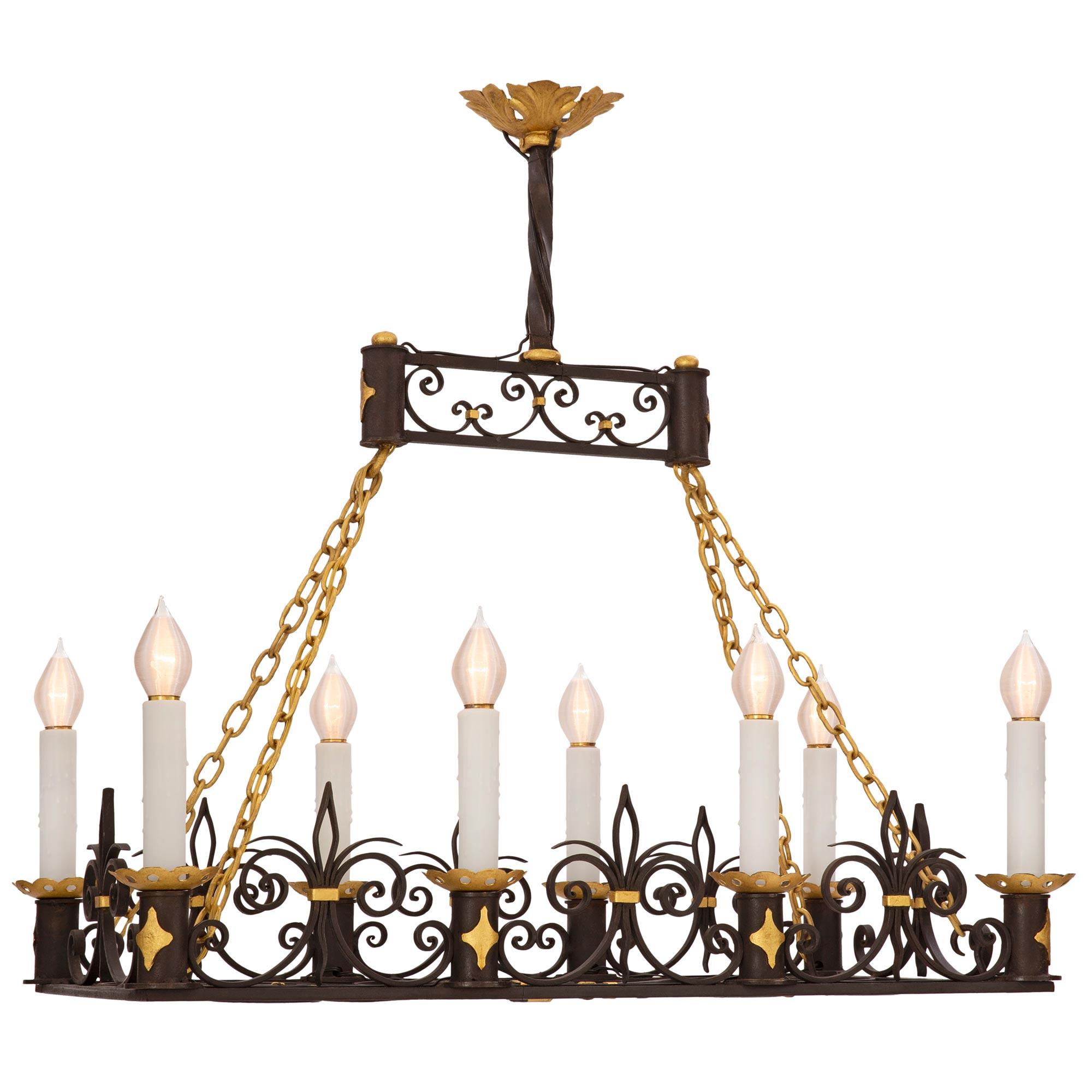 A striking and extremely decorative French 19th century Neo-Classical st. wrought iron and gilt metal chandelier. The eight arm chandelier displays a stunning pierced bottom design with superb scrolled movements with a central arrow shaped design