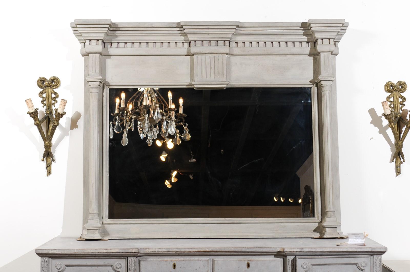 A French neoclassical style architectural element from the 19th century, made into a trumeau mirror. Born in France during the 19th century, this neoclassical style architectural element presents a linear silhouette beautifully adorned with