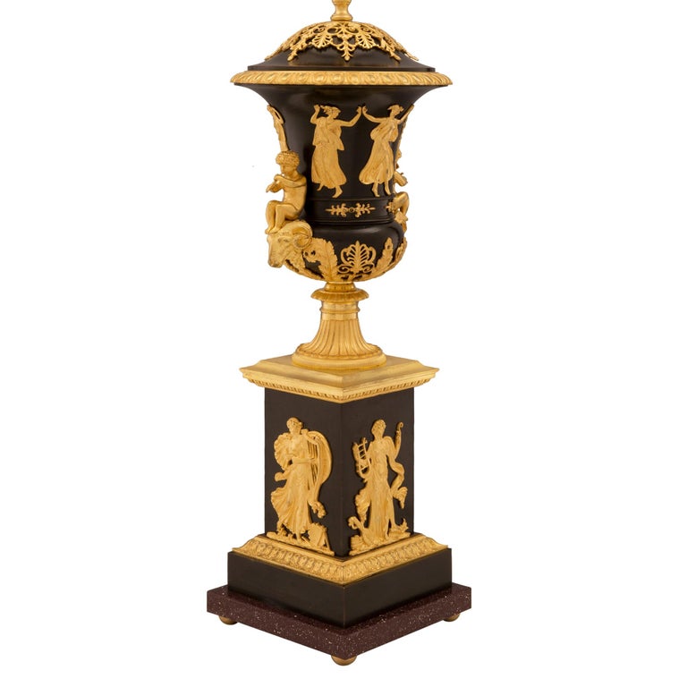 A striking and large scale French 19th century neo-classical st. patinated bronze, ormolu and faux painted Porphyry lamp. The lamp is raised by ormolu ball feet below a most decorative and wonderfully executed faux painted Porphyry bottom tier. The