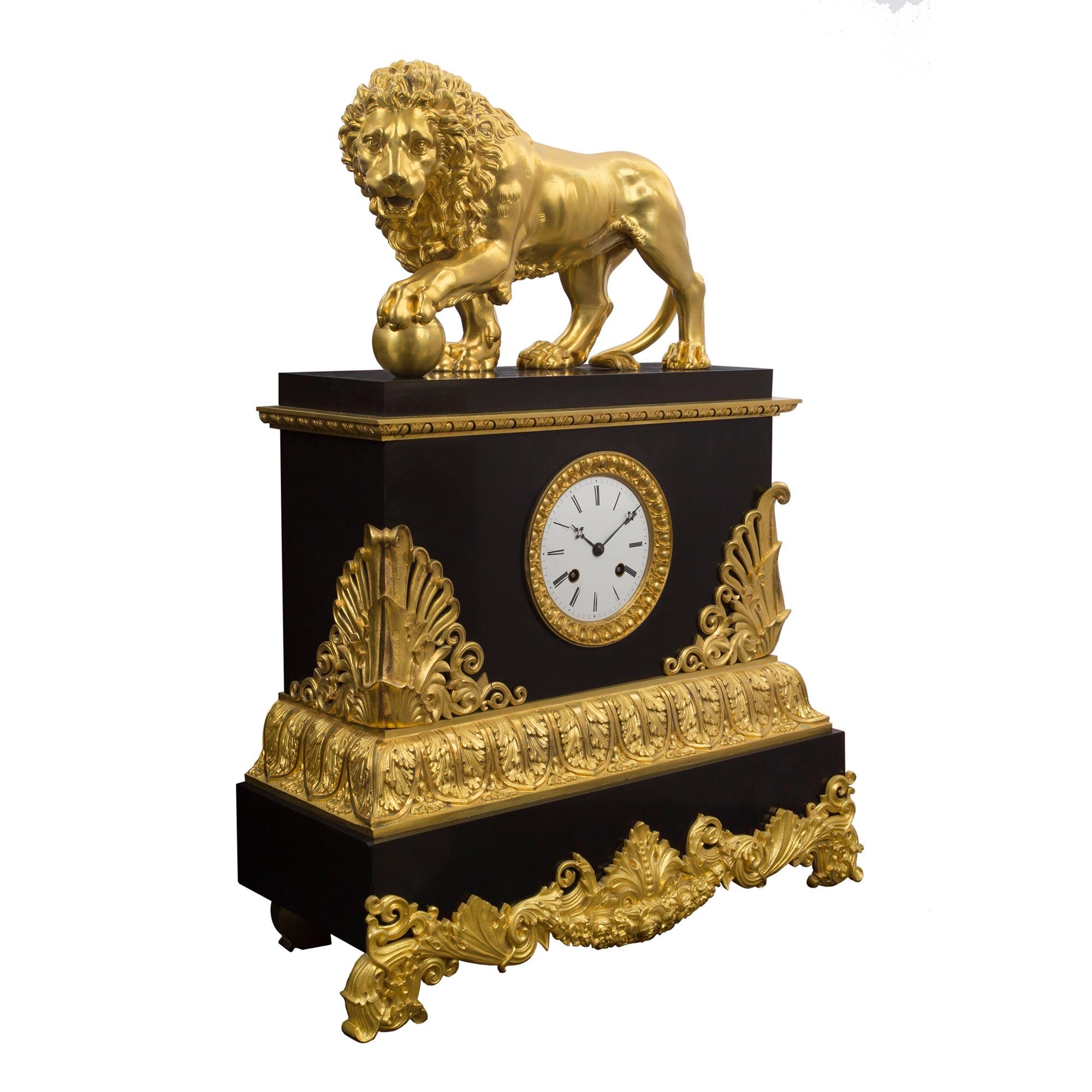 A sensational and important three piece French 19th century Neo-Classical st. black Belgian marble and ormolu garniture set. The clock is raised by a rectangular marble base with impressive finely chased ormolu mounted supports of scrolling foliage