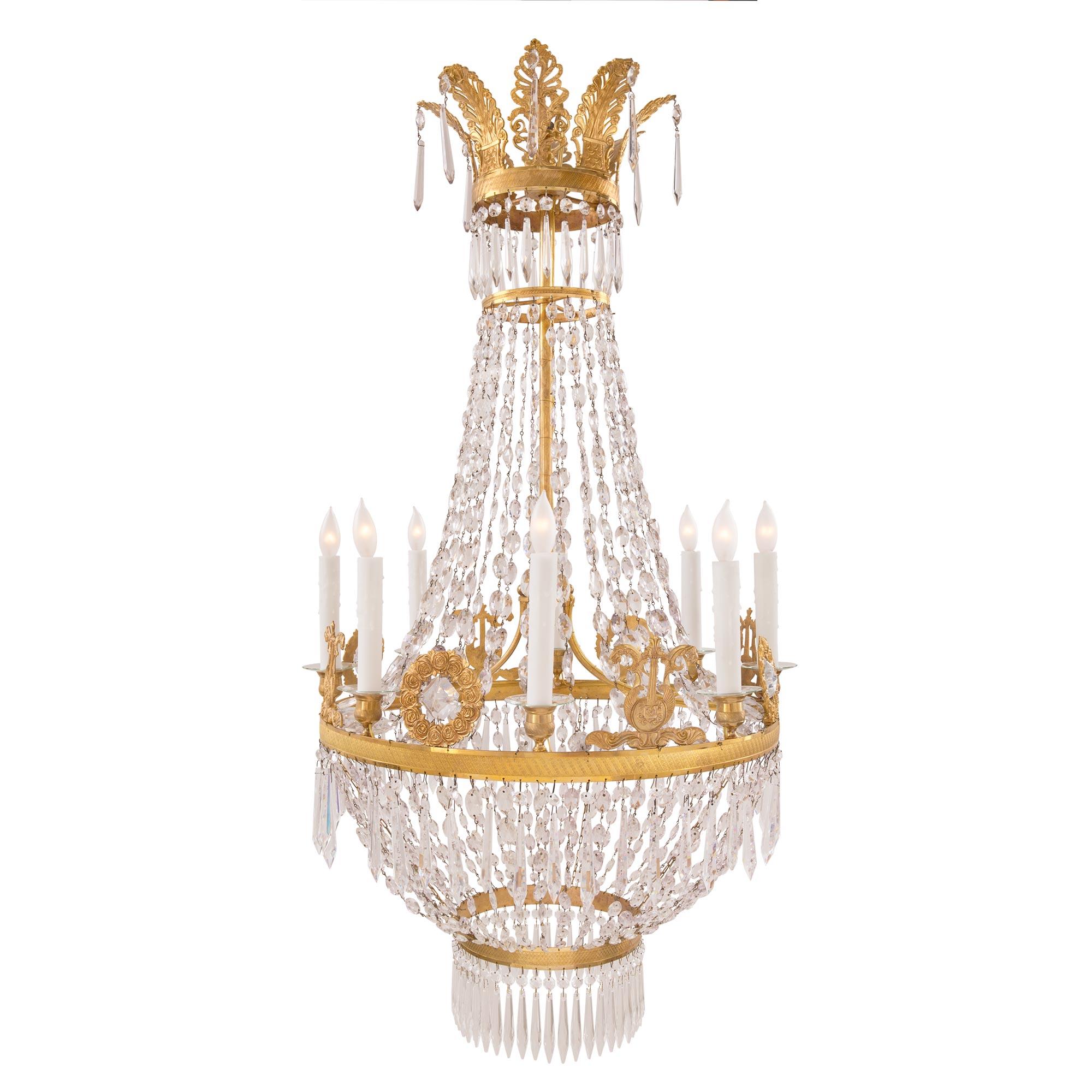 An exquisite French 19th century Neo-Classical st. ormolu and Baccarat crystal eight-light chandelier. The chandelier is centered by a lovely circular array of prism-cut crystal pendants tied to a fine ormolu bottom tier with a charming lattice