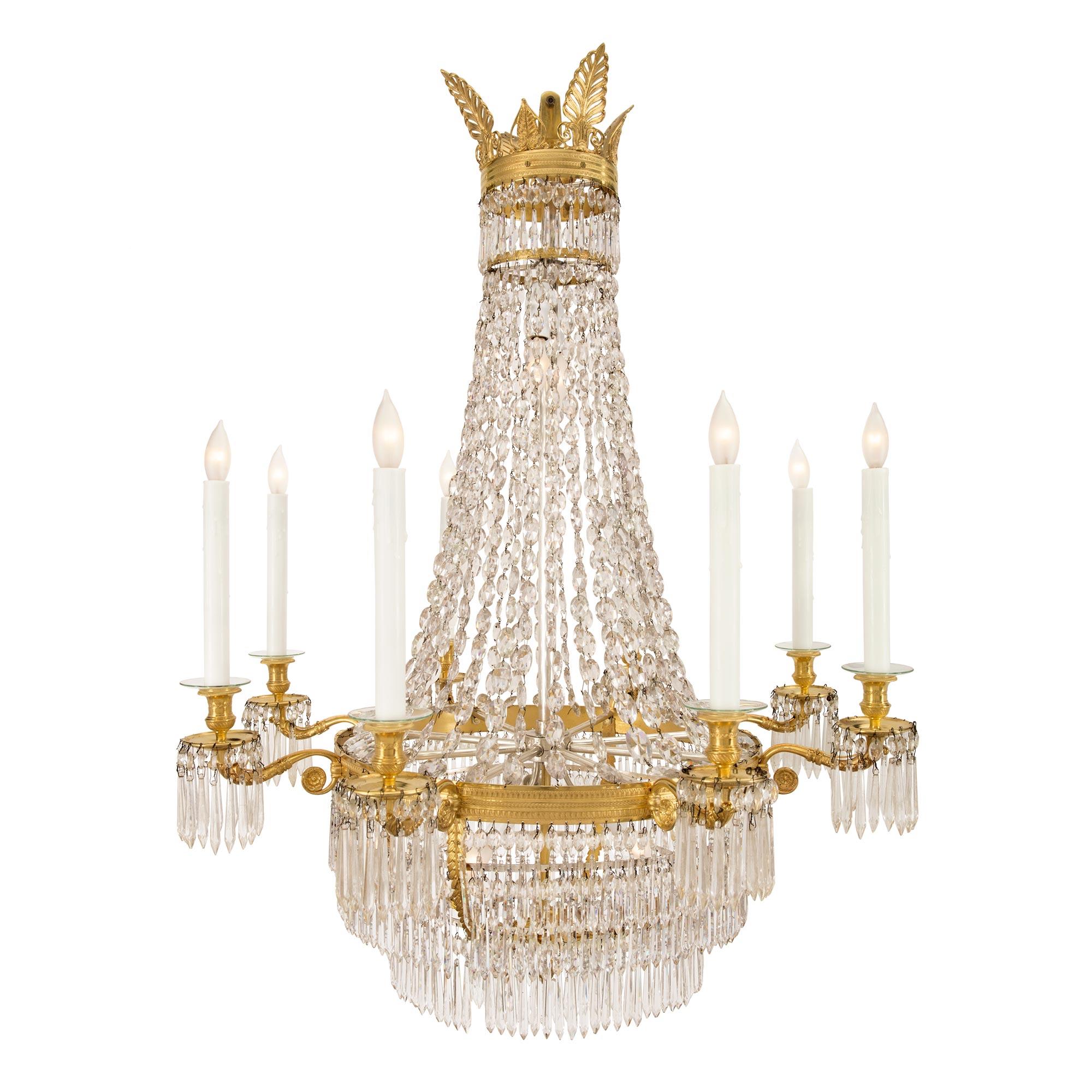 A most elegant French 19th century Neo-Classical st. ormolu and Baccarat crystal eight arm chandelier. The chandelier is centered by a striking acorn finial amidst fine overlapping foliate designs. Beautiful prism shaped cut crystal pendants spread