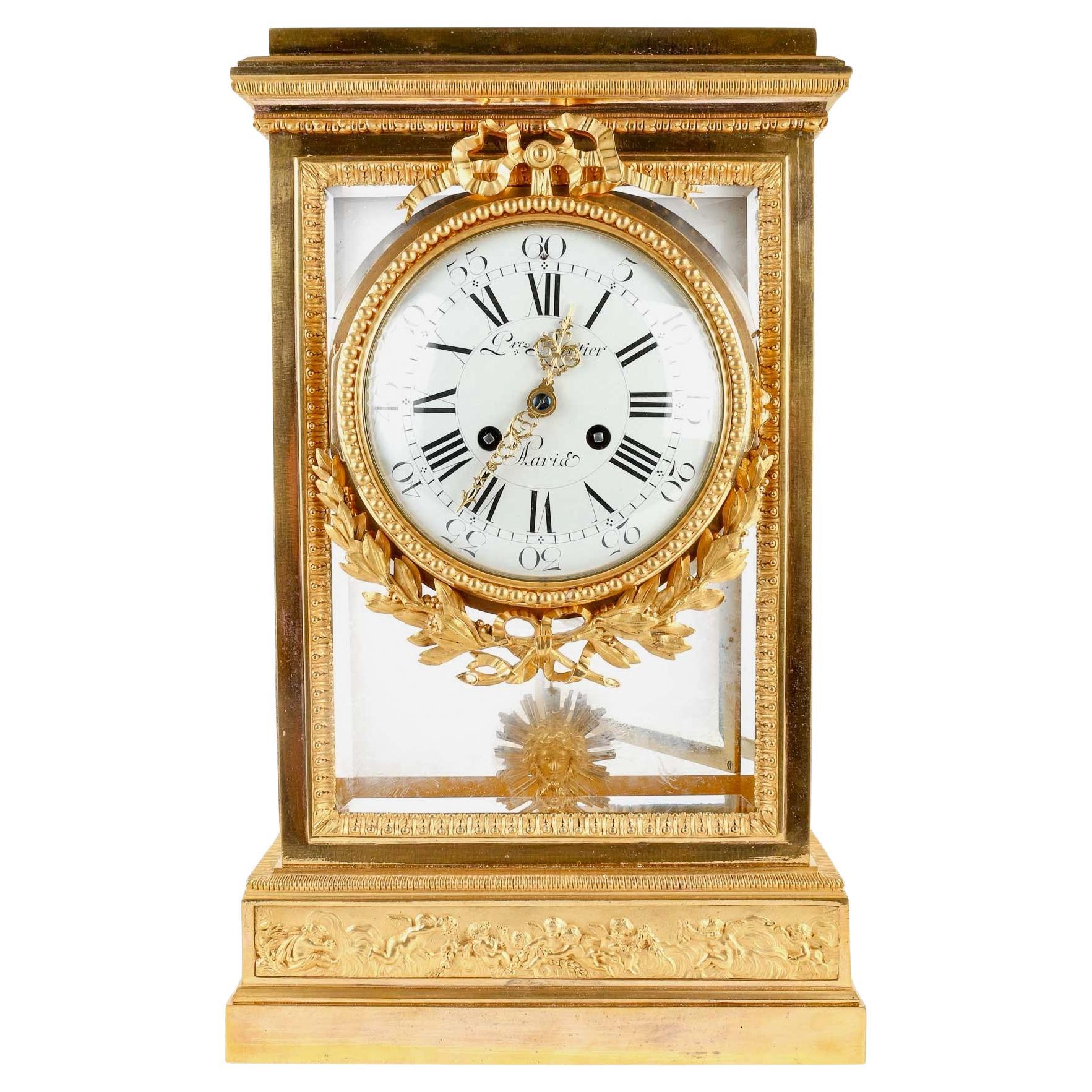 A 19th Century Neoclassical Style Régulateur de Cheminée 

Ormolu Mantel Regulator 
Very finely chiseled designed with ribbons and laurels crown, a cherub frieze on the plinth 
Bevelled Glass on Each Face
Enameled Dial signed Pierre Leurtier
