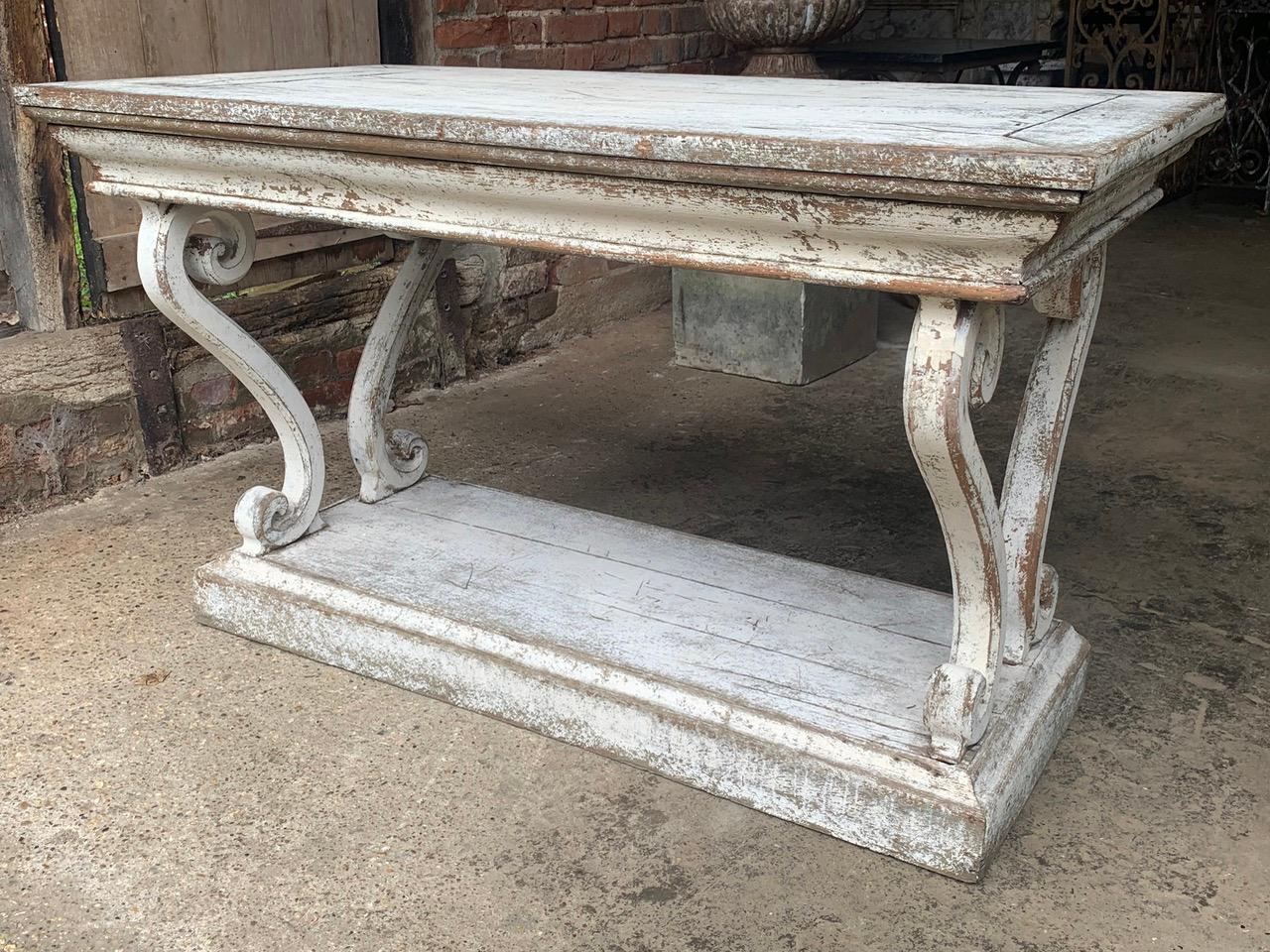 A beautiful early 19th century French oak drapers console table with gorgeous curved legs and nice old worn paint. The legs have wonderful elegant curves and scrolls giving it a great decorative look.

Please contact us for a shipping quote,
