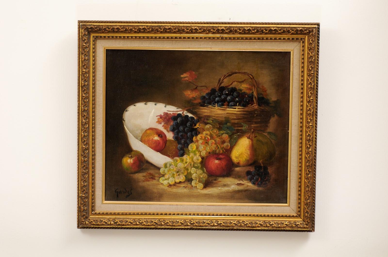 A French oil on canvas still-life painting from the 19th century, depicting fruits and set in giltwood frame. Created in France during the 19th century, this oil painting depicts a careful arrangement of mouth-watering grapes, pears and apples. The