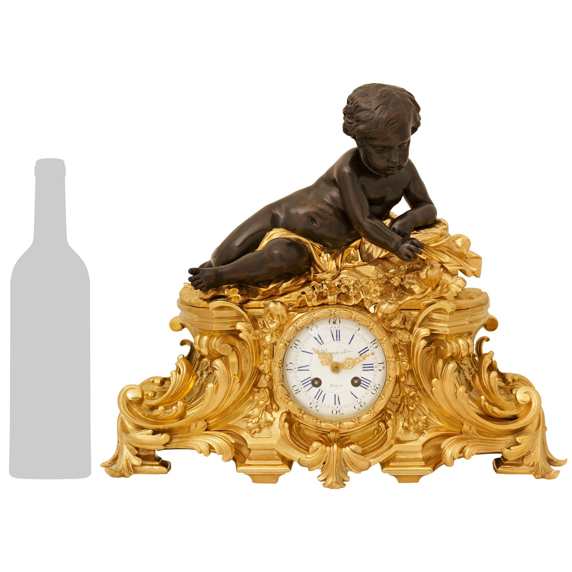 A elegant and high quality French 19th century Louis XV st. Belle Epoque Period Ormolu and patinated Bronze clock, signed by Raingo Freres. This stunning clock is signed by Raingo Freres and cast by Henri Picard, while being raised on an oblong and