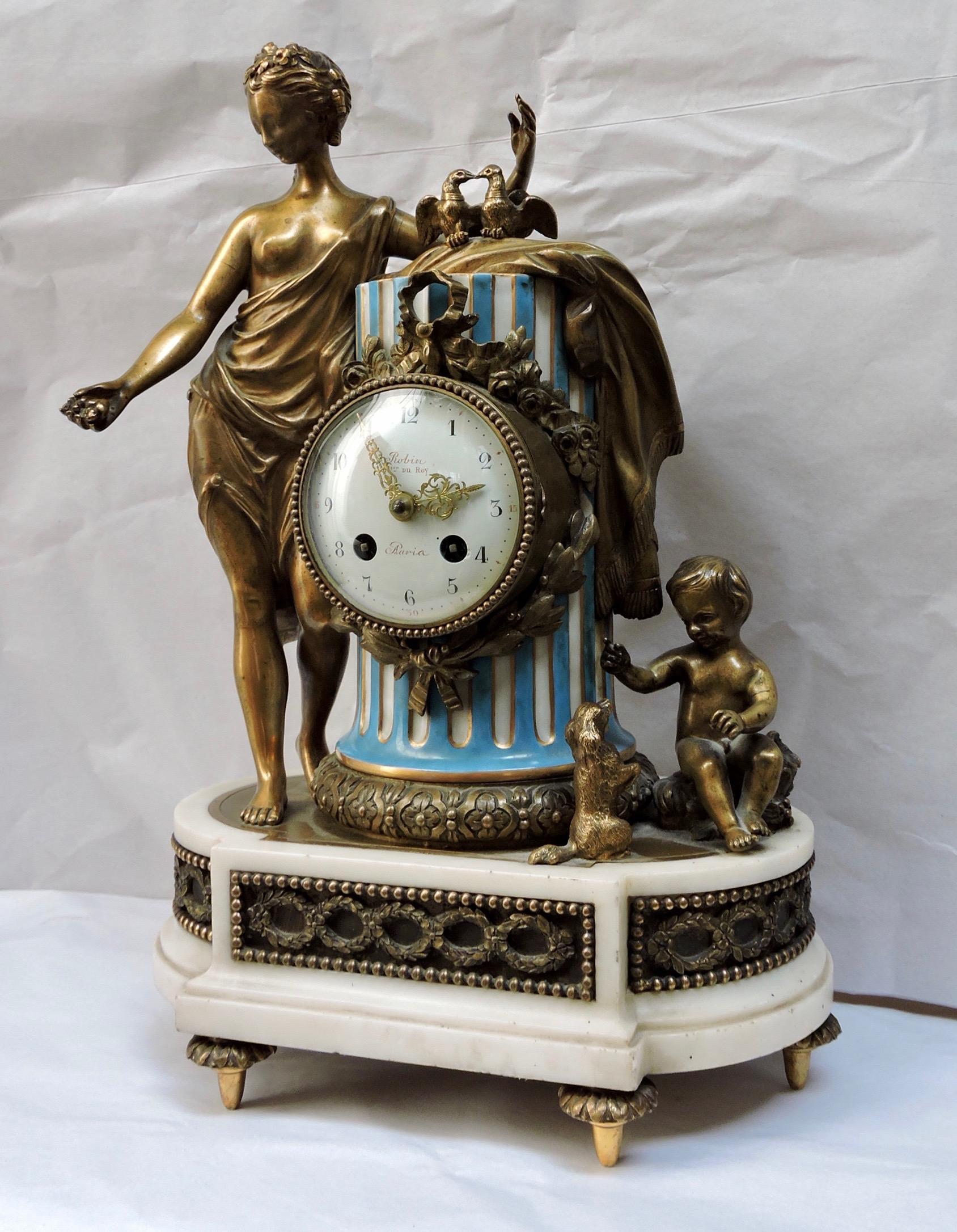 French 19th century ormolu and turquoise blue Sèvres Porcelain clock 
Designed with an antic draped woman with two doves , a putto playing with his dog.
Sèvres manufacture original painted mark
Numbered and with its original pendulum.
After the