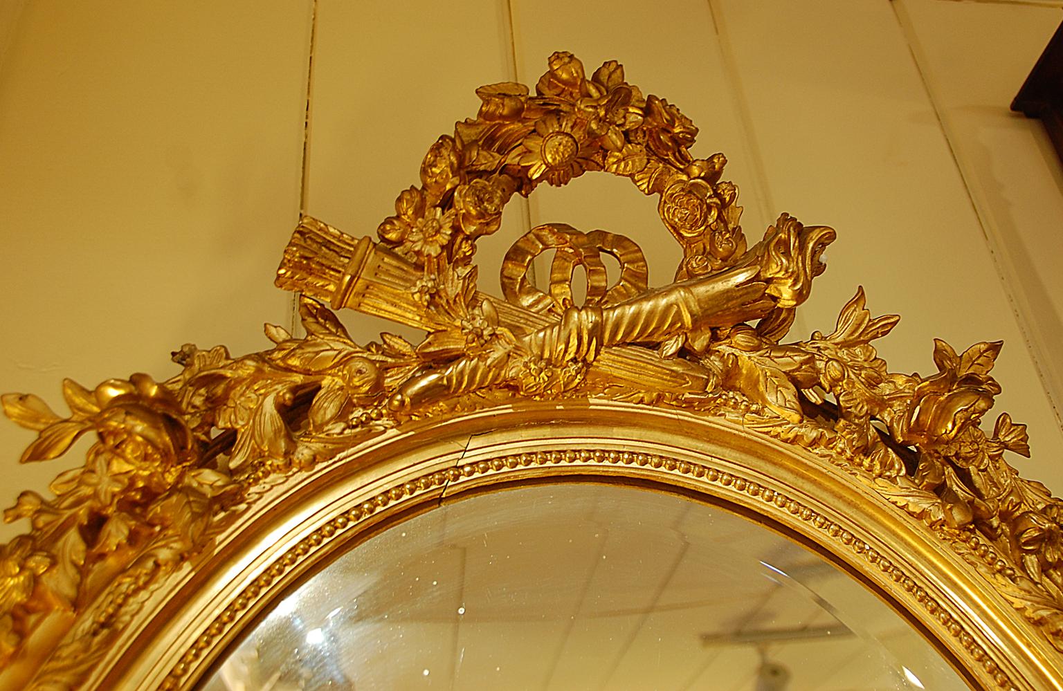 French 19th Century Oval Gold Leaf Carved Mirror, Torch, Quiver, Floral Motif For Sale 1