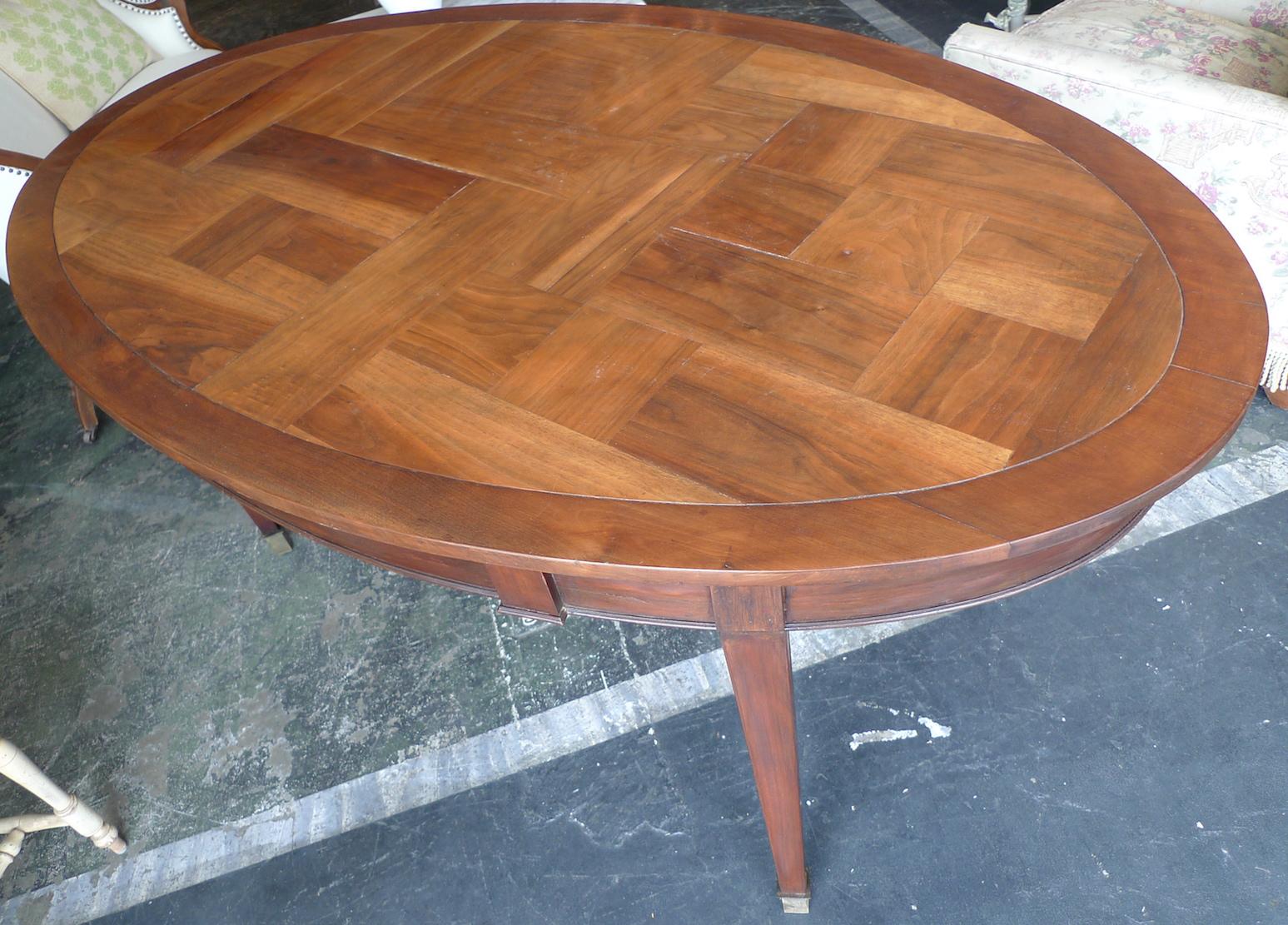 French 19th century oval mahogany dining table with walnut parquetry top.
