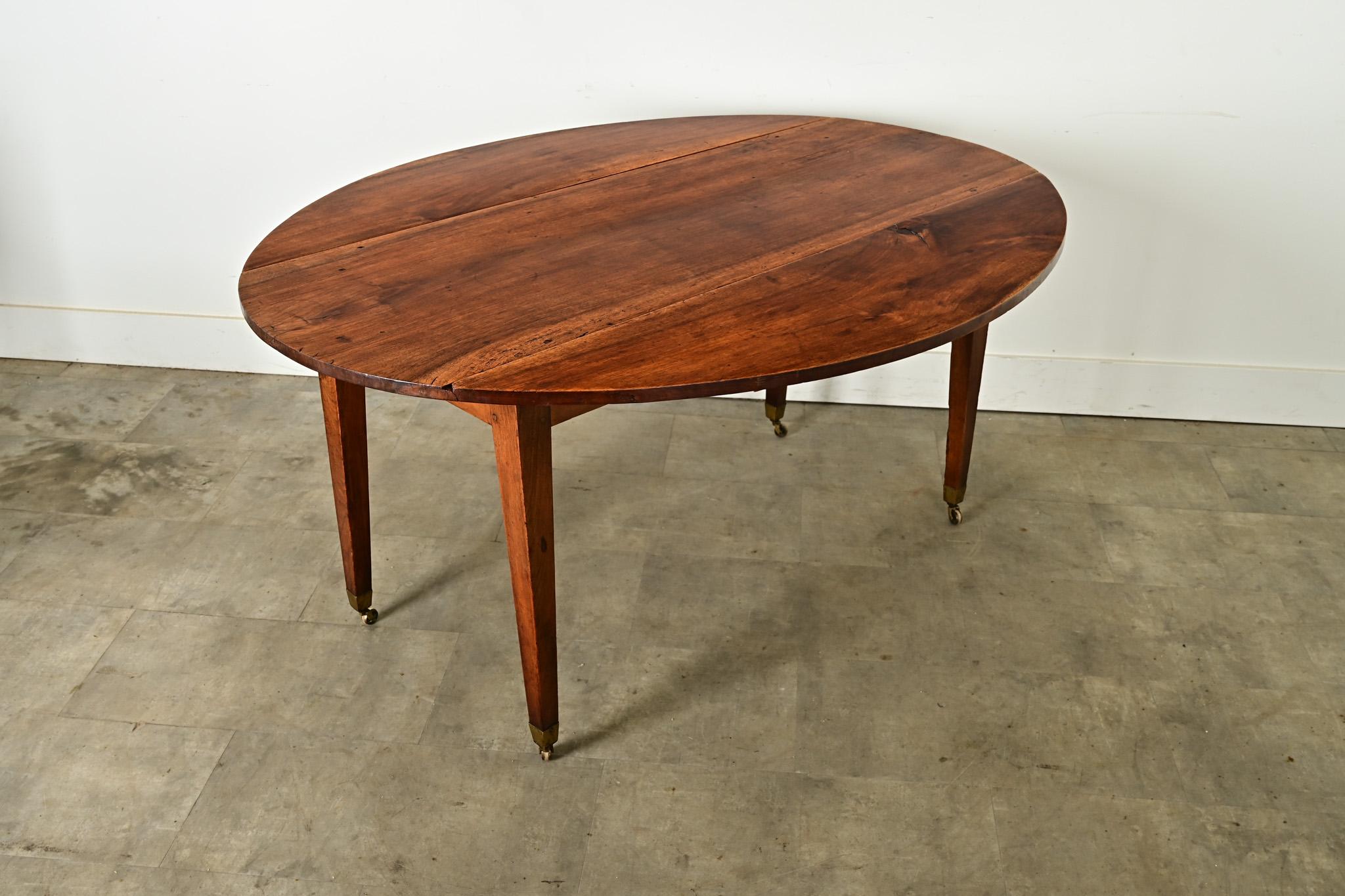 Preciosa mesa de comedor ovalada de nogal macizo con hojas abatibles, fabricada hacia 1860 en Francia. El centro de la encimera está hecho de una sola tabla. El rico nogal está maravillosamente patinado, con un bello veteado y una cálida coloración.
