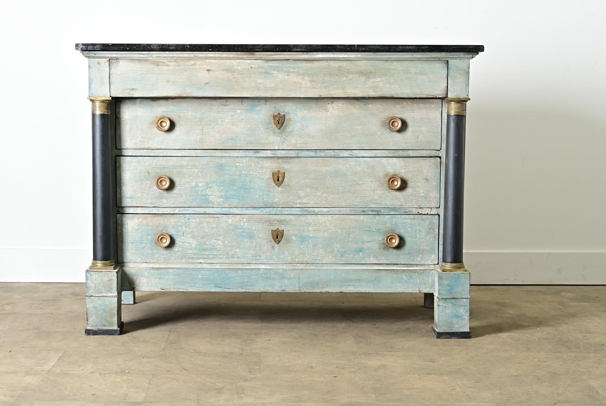 A French Empire walnut commode from the 19th century, updated more recently with blue paint in layered & scraped faux finish that wouldn’t look out of place with Gustavian style furnishings. The top is a slab of dark, nearly black marble flecked