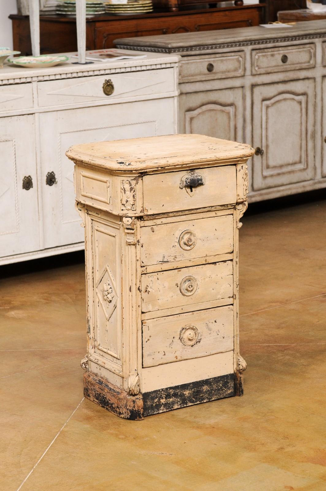 A French painted fir seeds counter from the 19th Century, with four drawers and nicely weathered appearance. Created in France during the 19th century, this fir seeds counter captures our attention with its rustic character and carved motifs.