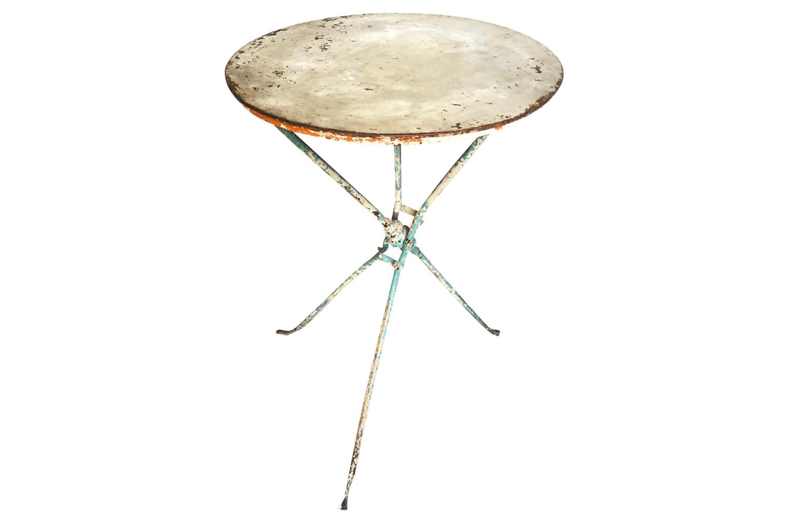 A delightful 19th century collapsible Bistro Table from the South of France in painted iron. Terrific patina. Perfect for any casual interior or exterior.