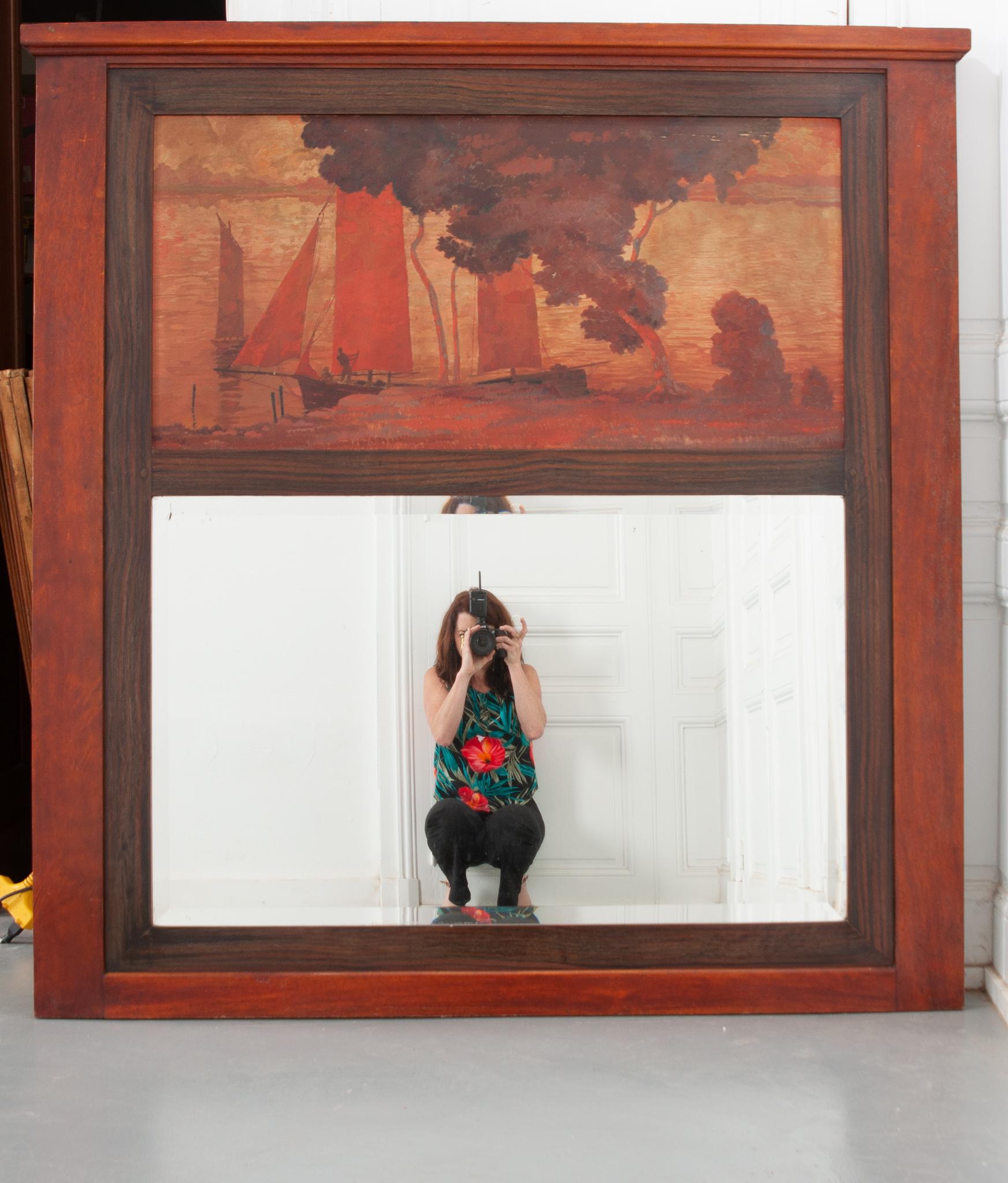 Un magnifique trumeau français du 19ème siècle. Encadrée en acajou et en bois de rose, une belle peinture à l'huile sur panneau représentant une scène côtière chaleureuse est fixée au-dessus du miroir. Le miroir biseauté est peut-être plus récent