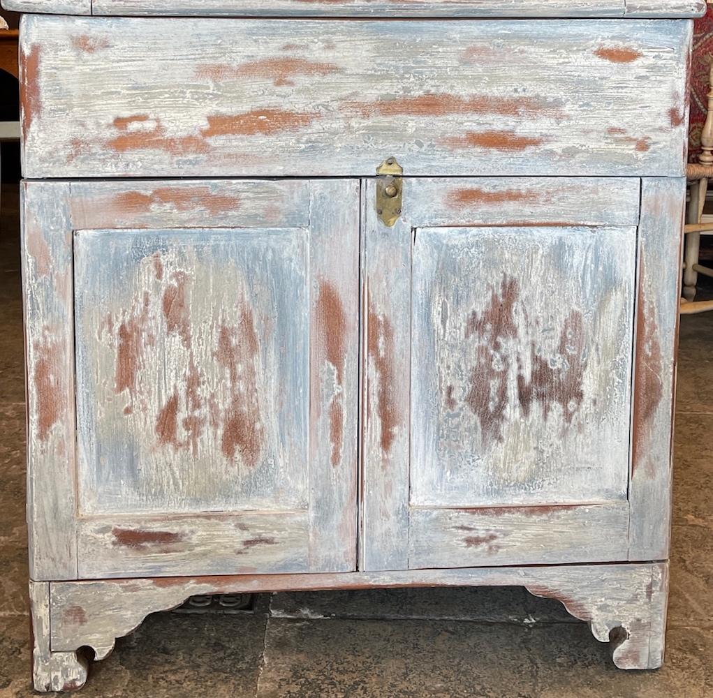 This is a very rustic painted 2 door buffet with a lift up lid to a storage compartment. There is one shelf inside the double doors.