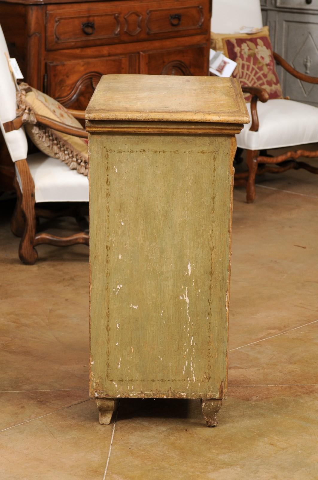 A French painted wood buffet from the 19th century, with one drawer over two doors and fluted side posts. Created in France during the 19th century, this painted buffet features a rectangular top with beveled edges, overhanging a single drawer