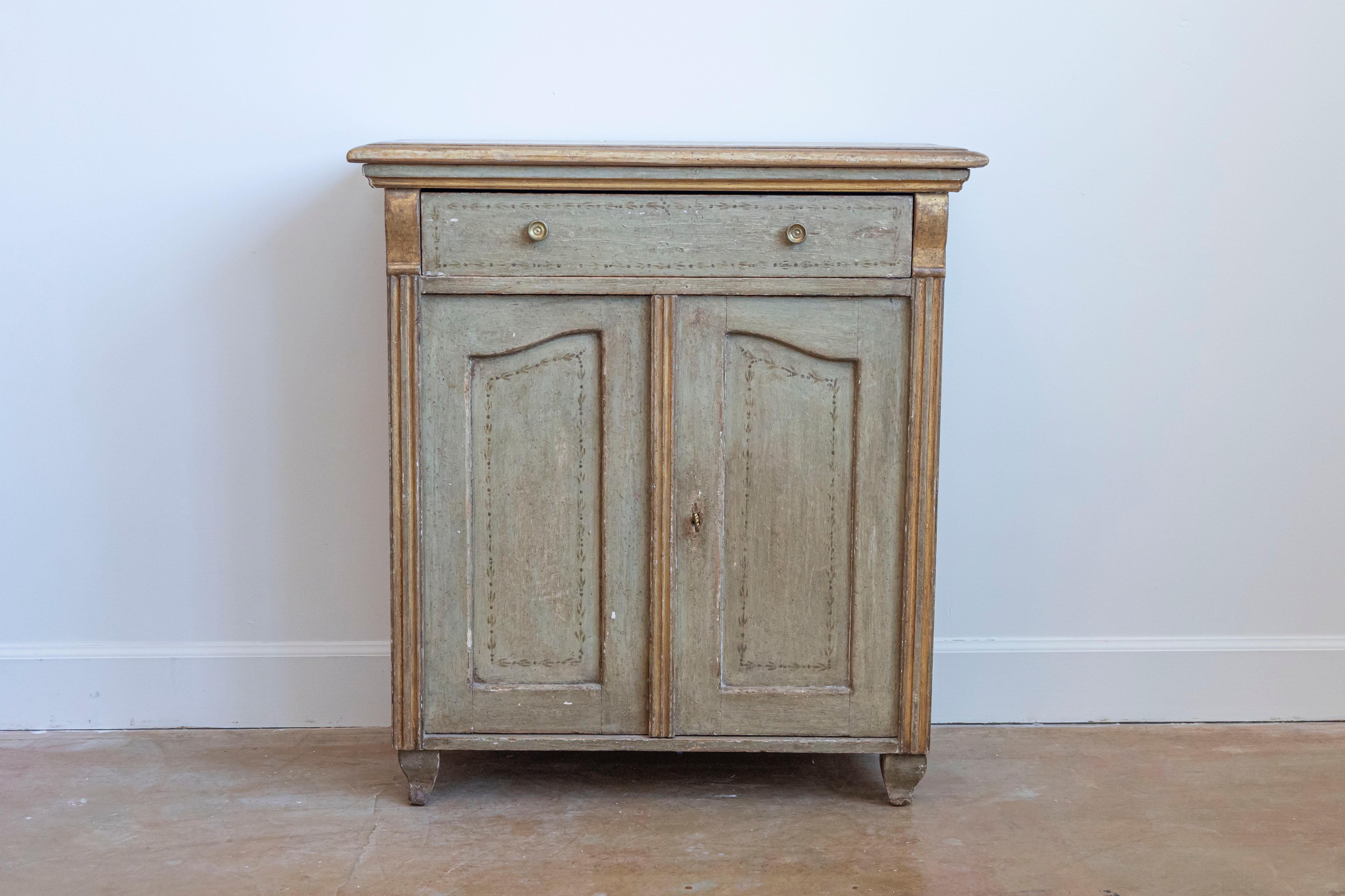 A French painted wood buffet from the 19th century, with one drawer over two doors and fluted side posts. Created in France during the 19th century, this painted buffet features a rectangular top with beveled edges, overhanging a single drawer