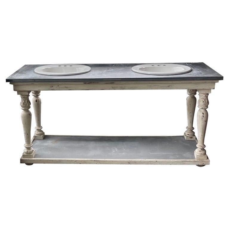 This is a very unique vanity piece of French 19th century Furniture. The vanity is made of a painted pine structure. On top there is a zinc covering with 2 porcelain sinks. The piece is very useable in the 21st Century.