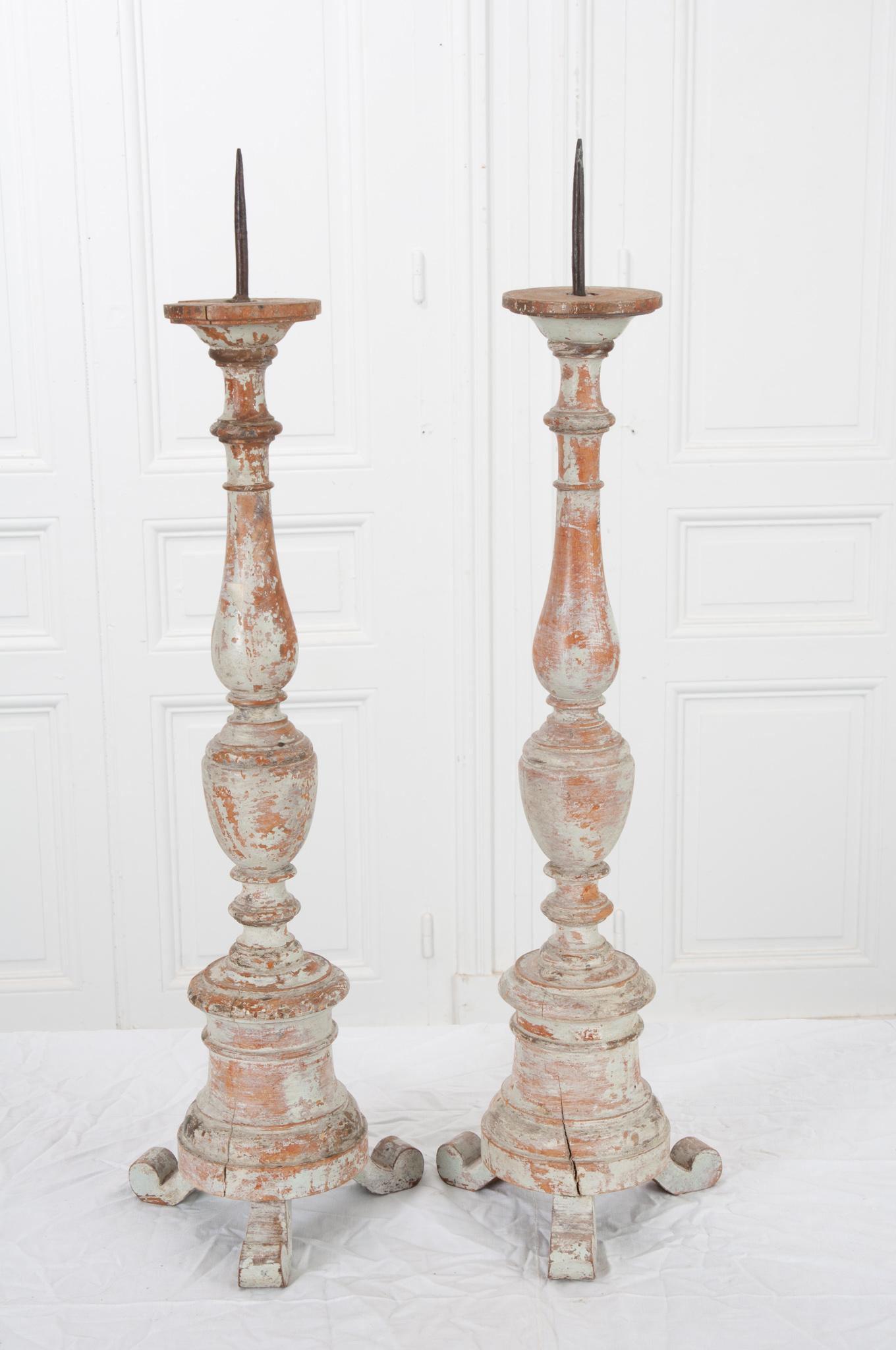 This attractive pair of French candlesticks were made in the late 1800’s. The impressively turned wood still features the original paint, worn over the years giving them a great patina. Iron spikes will hold your candle of choice securely in place.