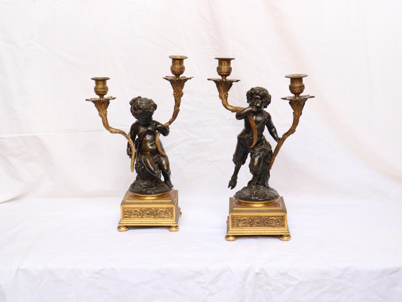 A French 19th century pair of Faune and Bacchus candelabras
Two lights sprouting from sheaves of foliage held by patinated bronze figures of a Faune and Bacchus on ormolu square base.
Louis XVI style,
circa 1880.
After Claude Michel Clodion.