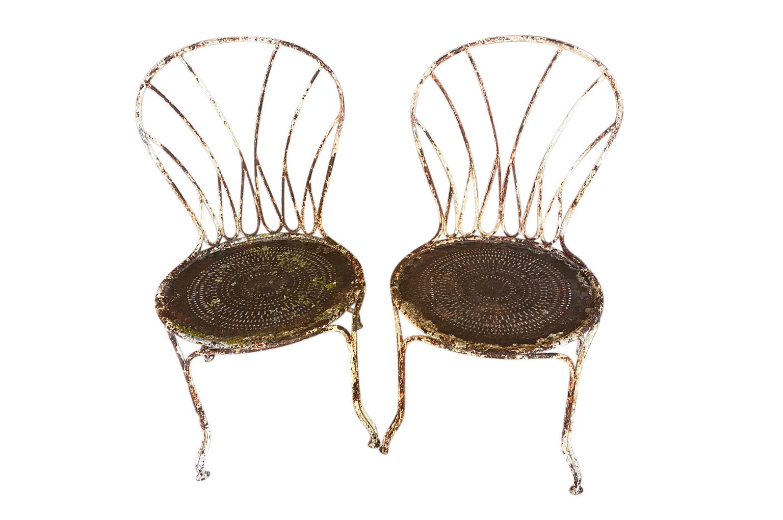 A very lovely pair of later 19th century Garden chairs from the Provence region of France. Soundly constructed from painted iron. Perfect for the interior or garden. The seat height is 16