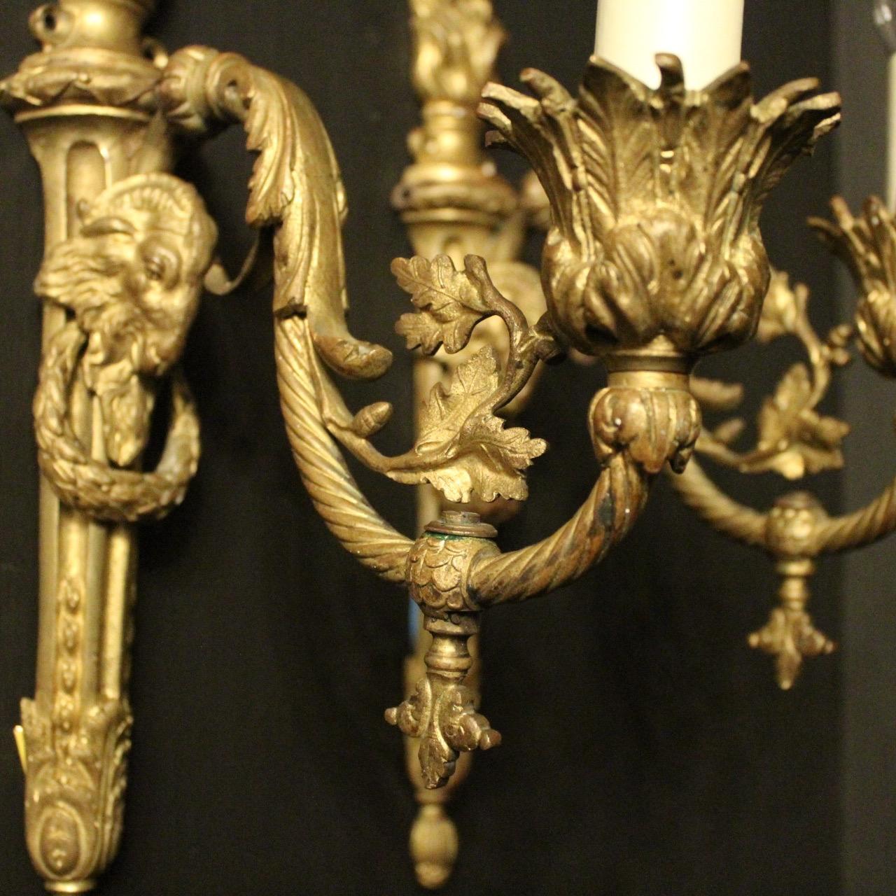 A French pair of Ram headed gilded bronze single arm antique gasolier wall lights, the ornate barley twisted leaf clad scrolling arms with trumpet leaf bobeche drip pans, issuing from a decoratively cast ram headed tapering reeded backplate with