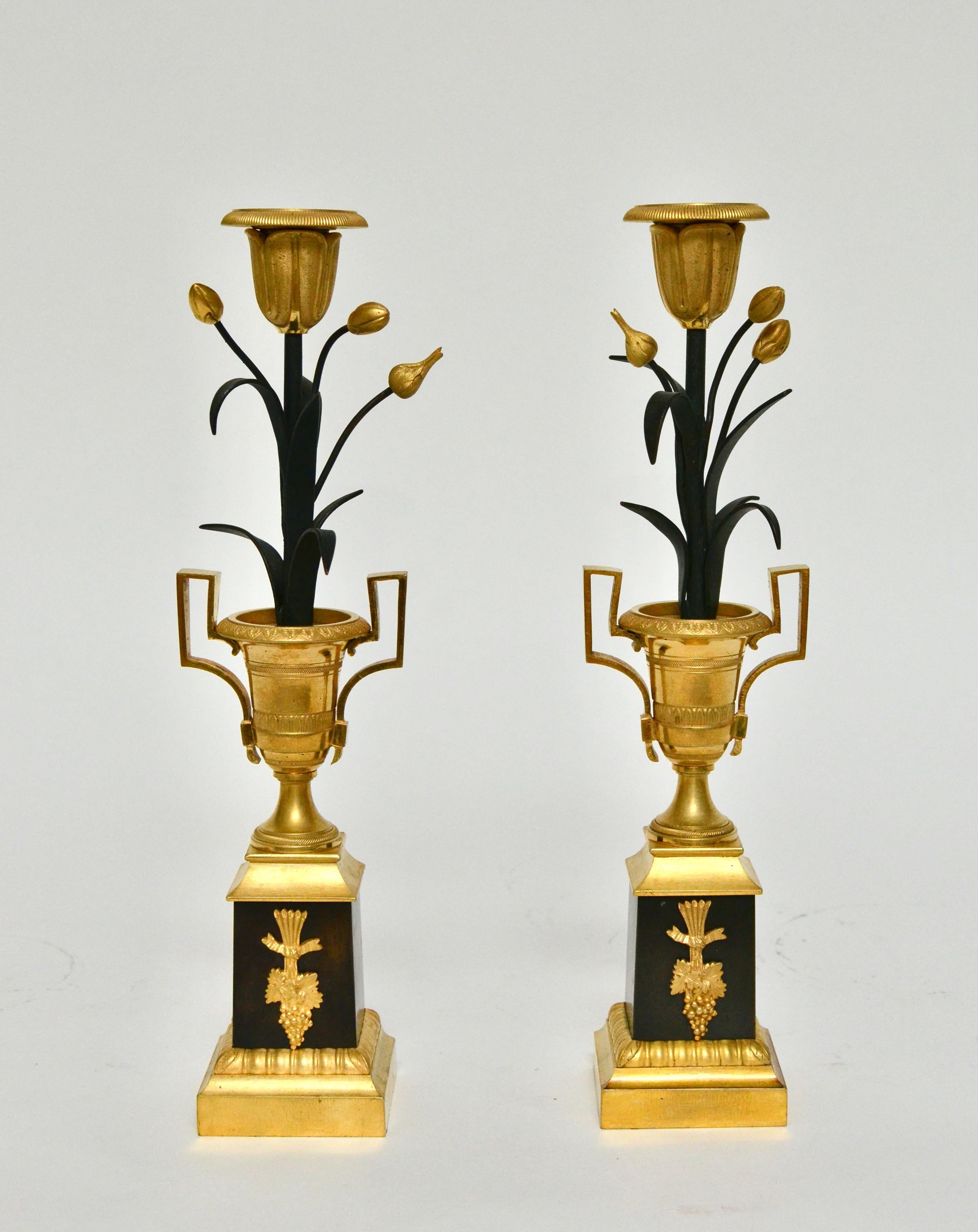 A 19th century French pair of gilt and patinated candlesticks. A very unusual model. Very fine detailing to the chasing of the bronze and the candlesticks are in a very nice condition. 